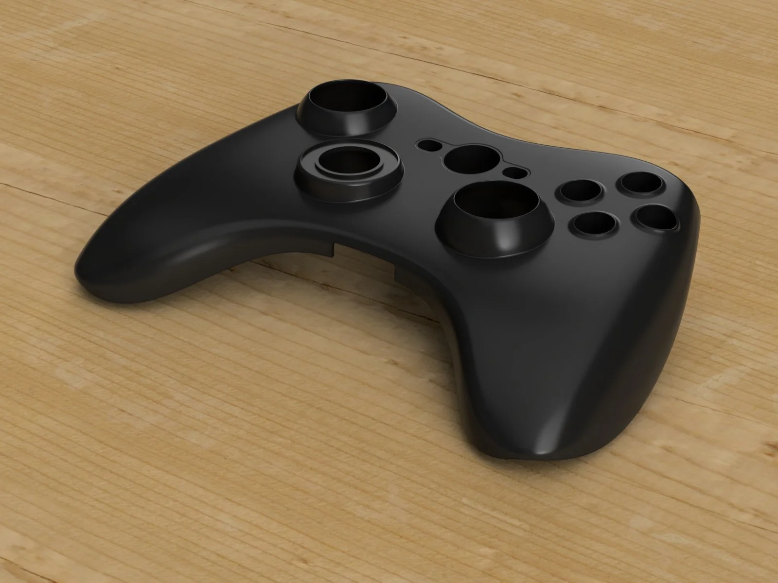 Manette de jeu vidéo noire sans boutons, placée sur un plan en bois.