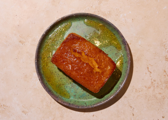 Homemade cornbread, a fan favorite, topped with honey and sea salt.