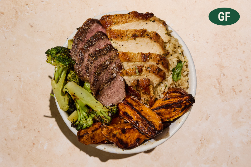 High Protein Plate with sliced steak, chicken, broccoli, sweet potatoes, and brown rice.