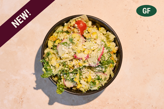 Charred corn salad with roasted corn, cabbage, radish, lime, and cotija cheese.