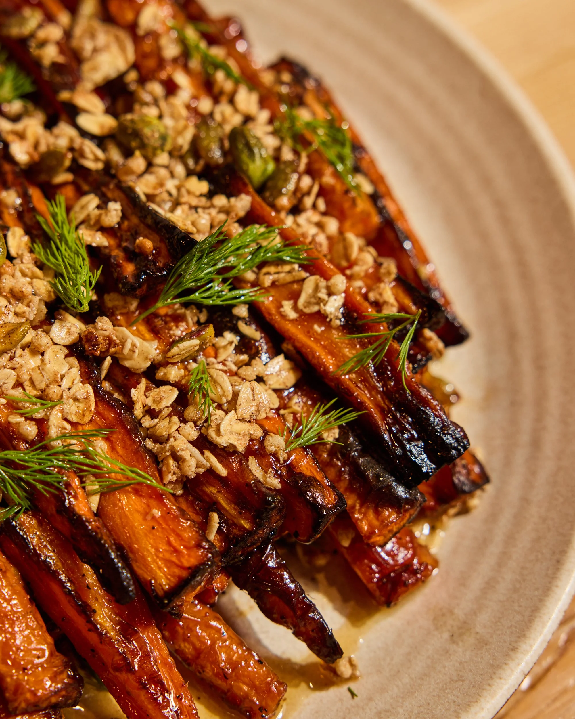 Locally-sourced and seasonal Maple Glazed Carrots. Topped with oats