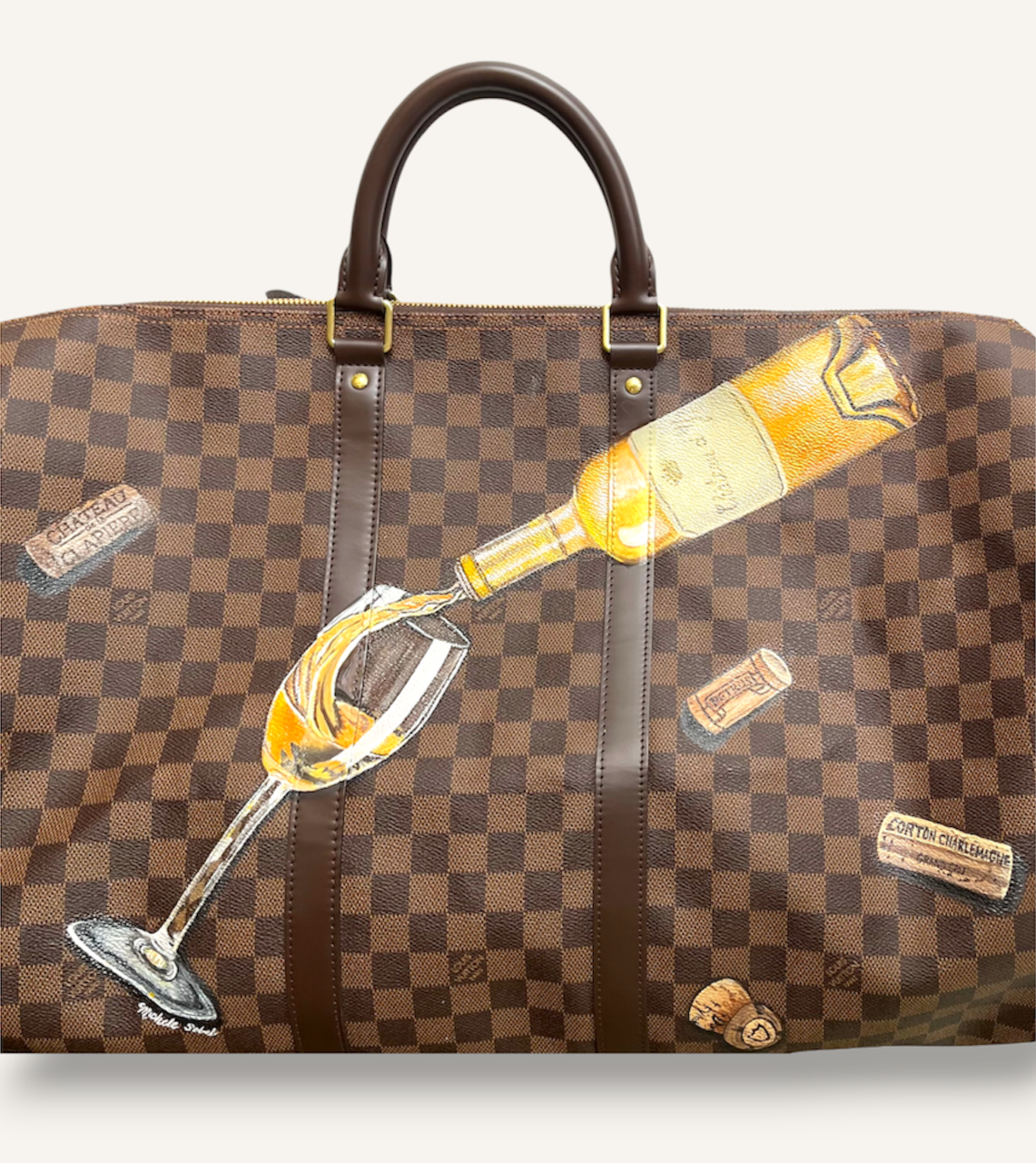 A wine collector travels in style with his favorite French wines and corks painted on his travel bag. 
