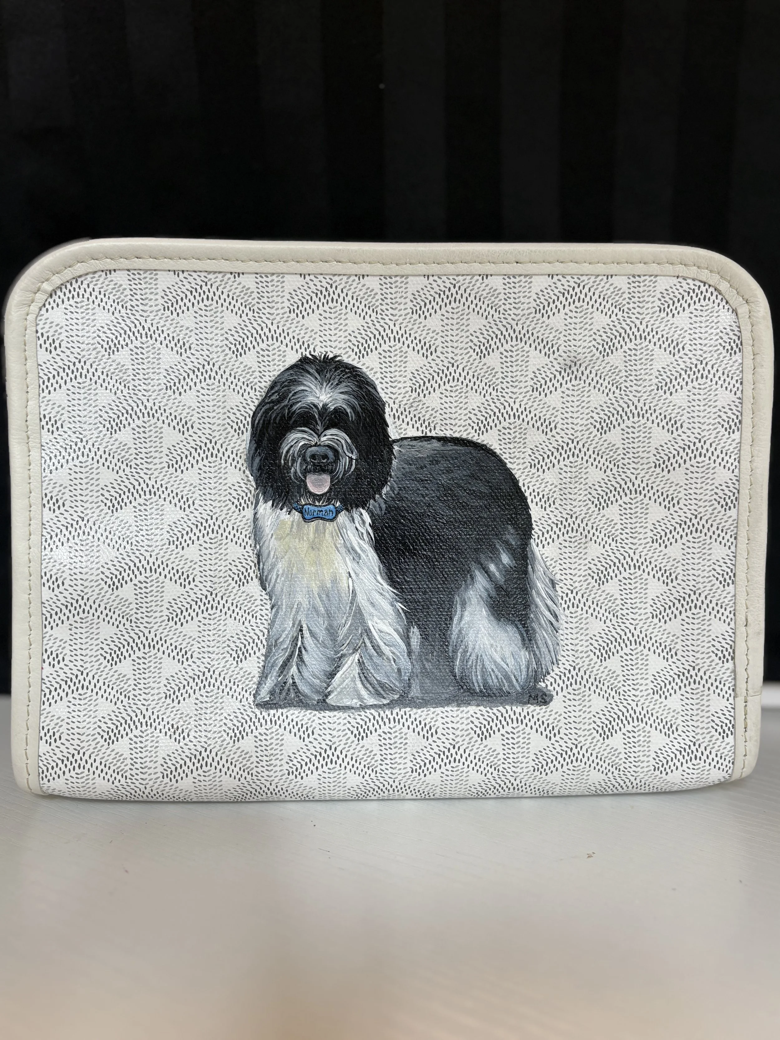 A surprise pet portrait painted on a Goyard, for mom, of her dog. She loved it so much she commissioned one for her friend the next year.
