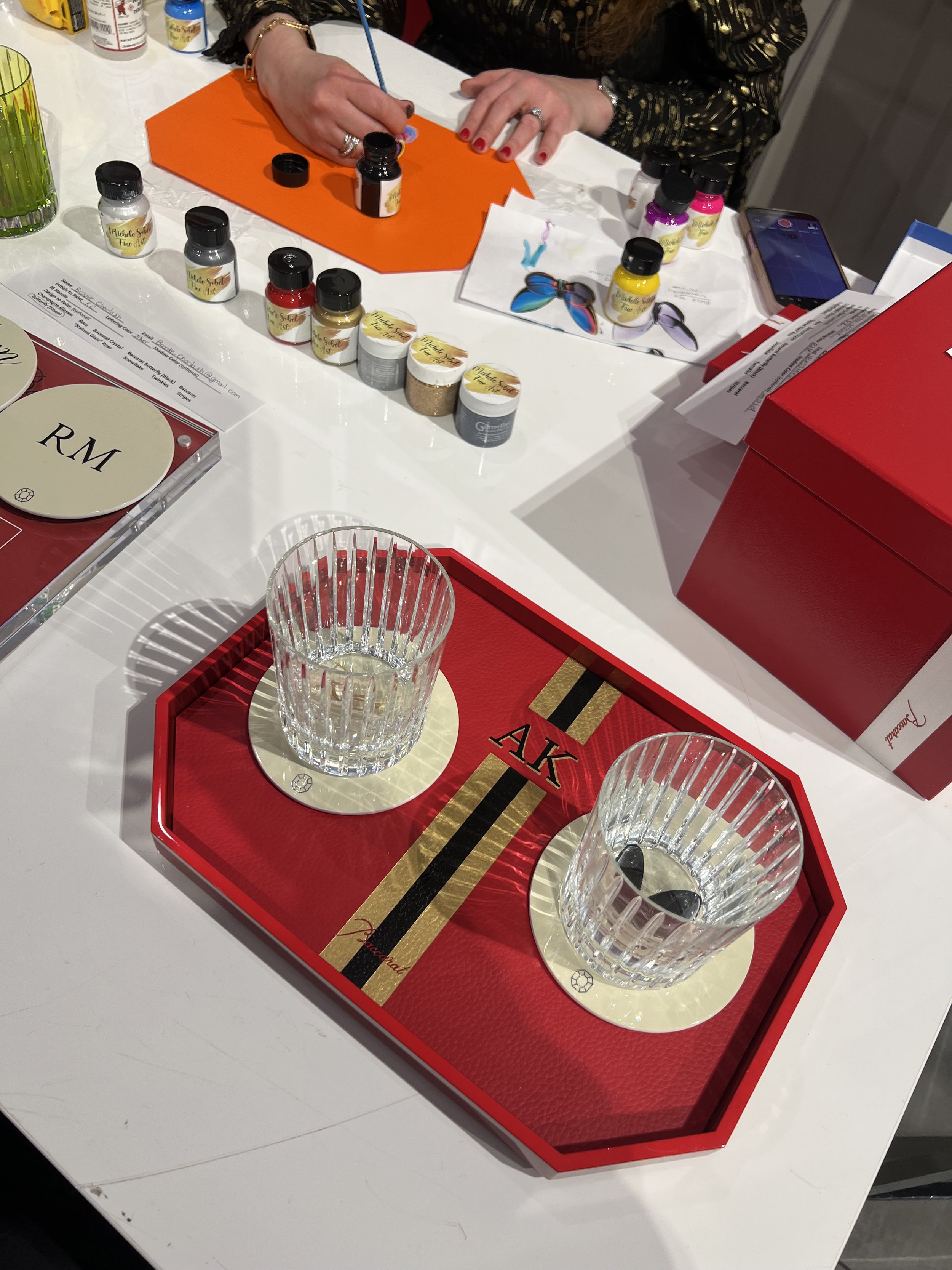 Hand-painted customization for Baccarat. The first time the brand partnered with an artist in the US. Michele Sobel Fine art painted coaster sets, luxury trays and crystal gift boxes with bespoke designs, monograms and brand-inspired art for a succes