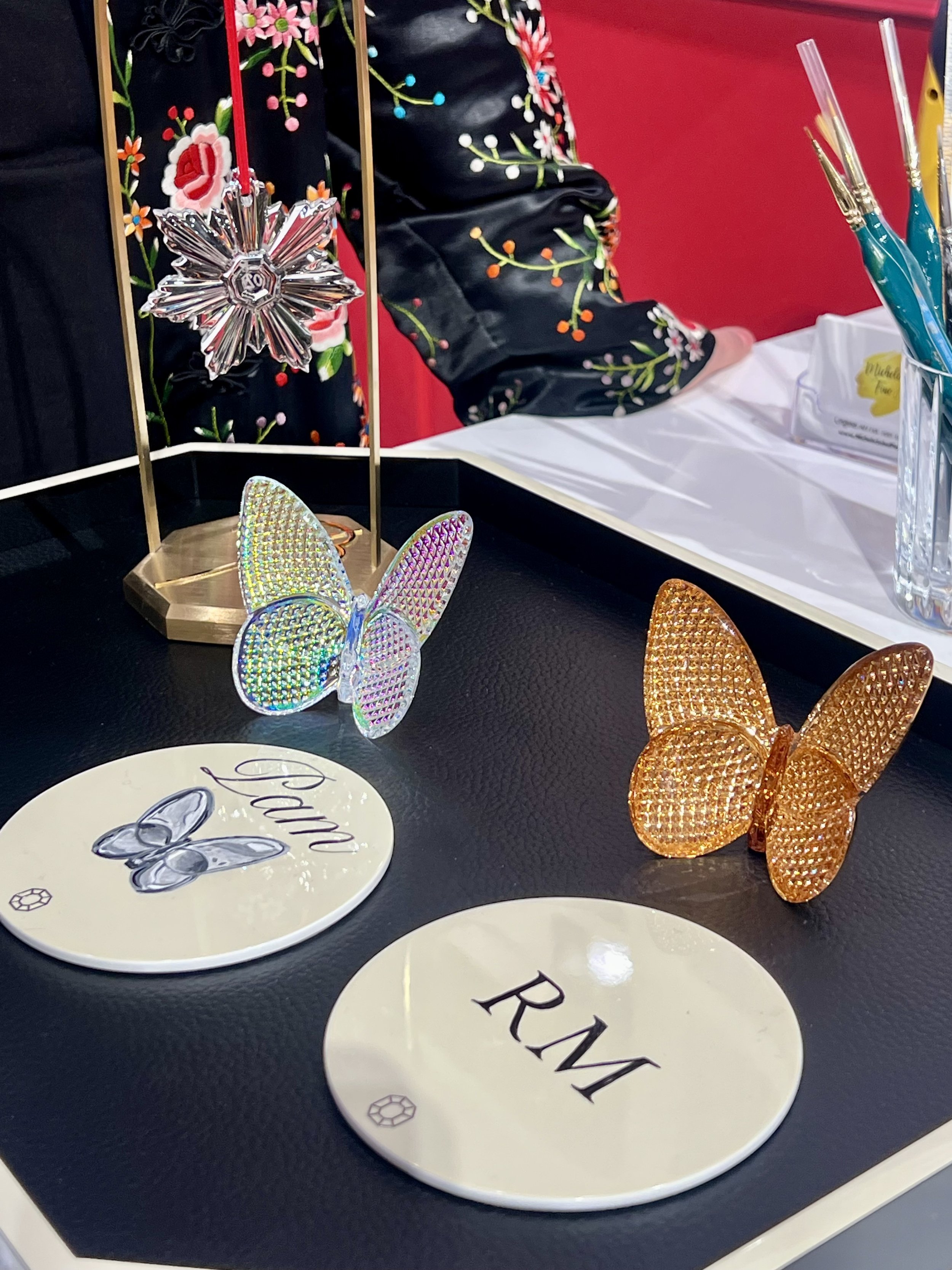 Hand-painted customization for Baccarat. The first time the brand partnered with an artist in the US. Michele Sobel Fine art painted coaster sets, luxury trays and crystal gift boxes with bespoke designs, monograms and brand-inspired art for a succes