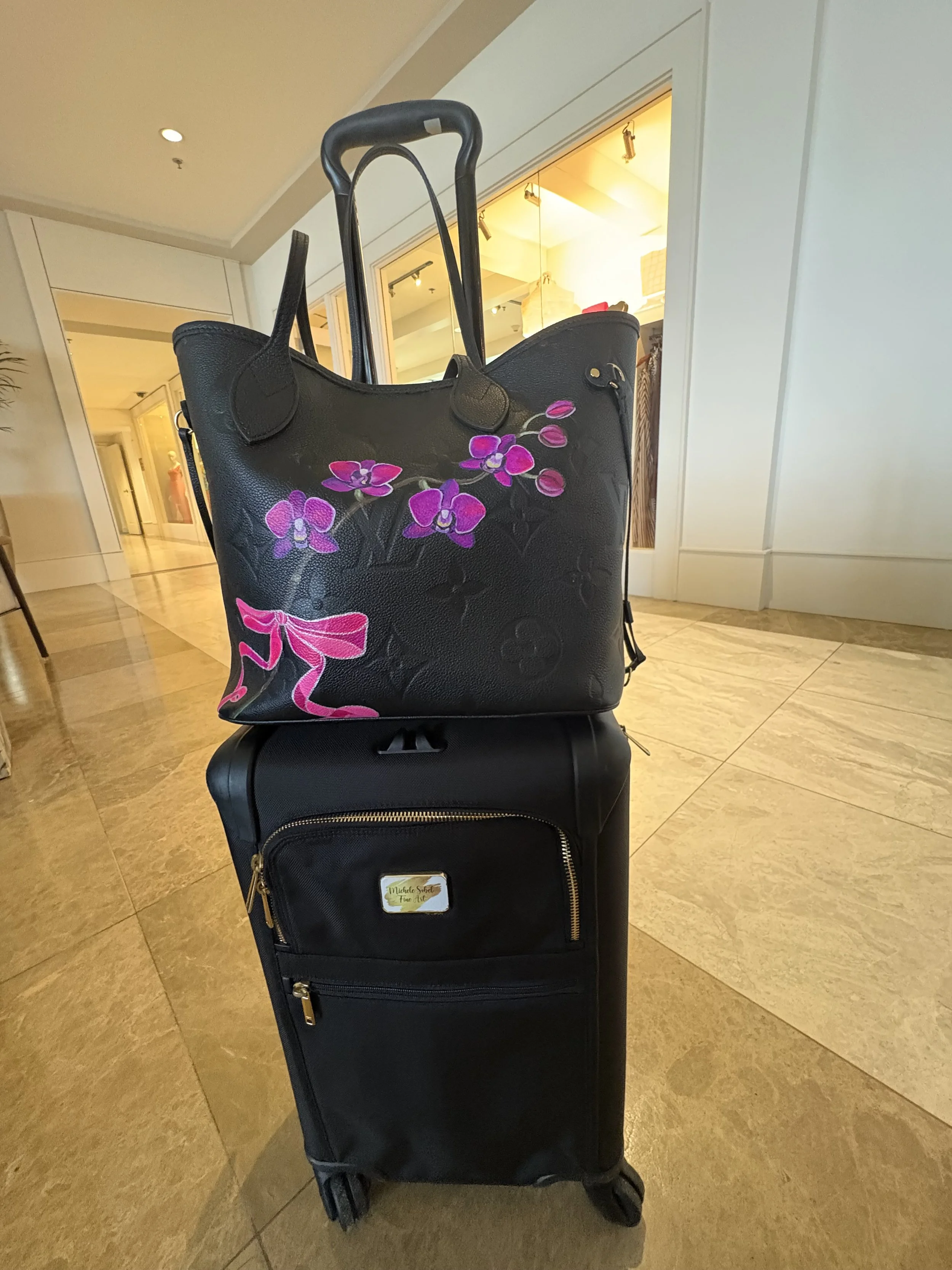 The custom painted by Michele Sobel Fine Art bag that makes every travel look feel fashion forward.