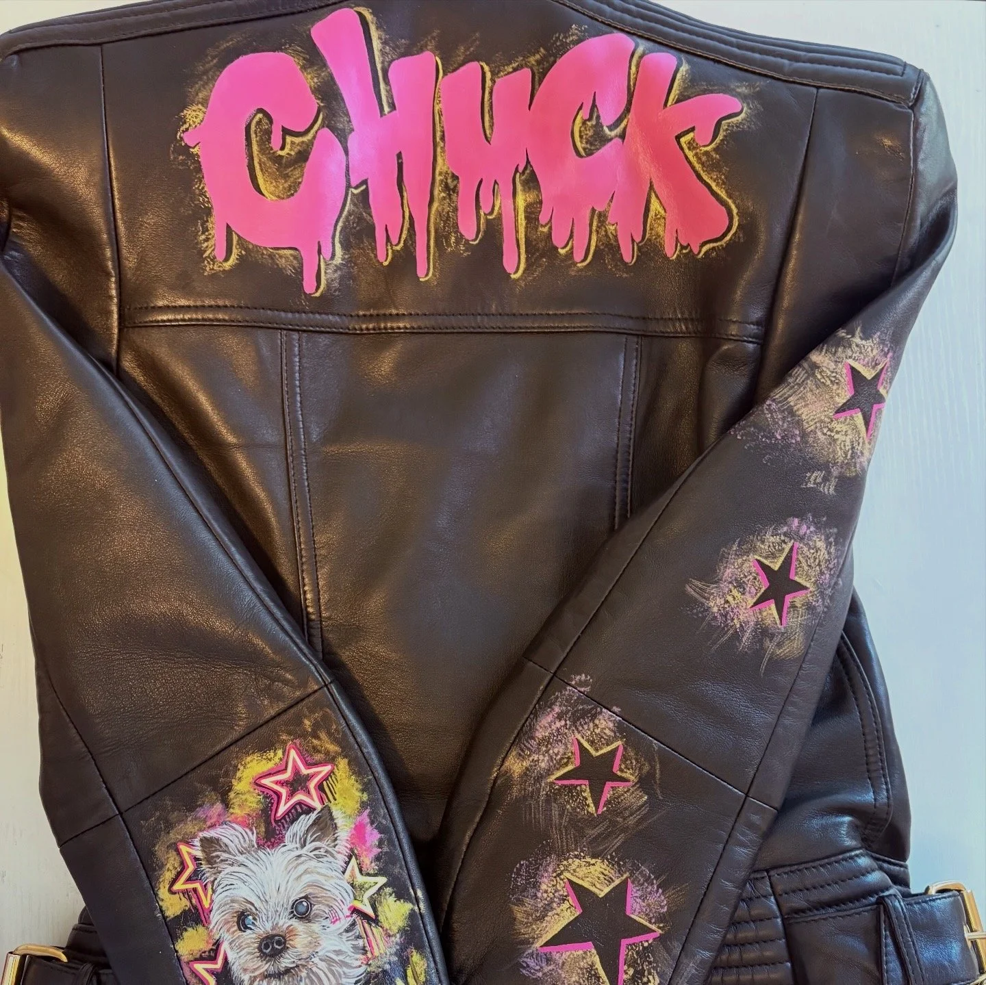 Pop art portrait of her pet dog and nick name on a Balmain leather jacket.