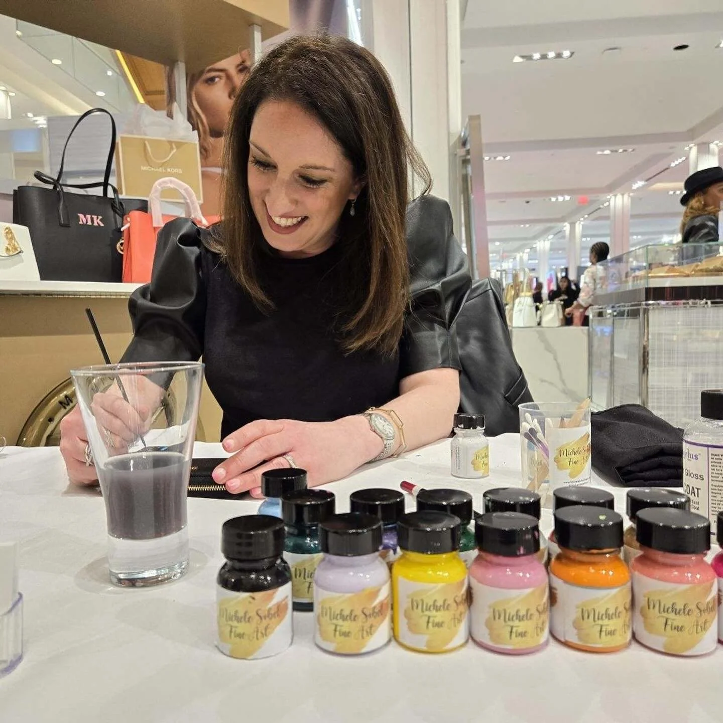 Bespoke hand painting activation for Michael Kors over Valentines Day . Michele Sobel Fine Art handprinted bags for the luxury  handbag brand in Macys Herald Square NYC flagship