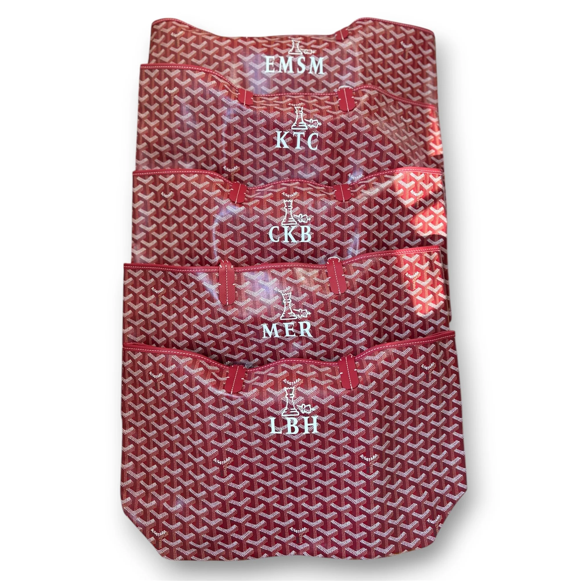 Bespoke holiday corporate gifting for finance company. Goyard bags with monograms and the company logo by Michele Sobel Fine art