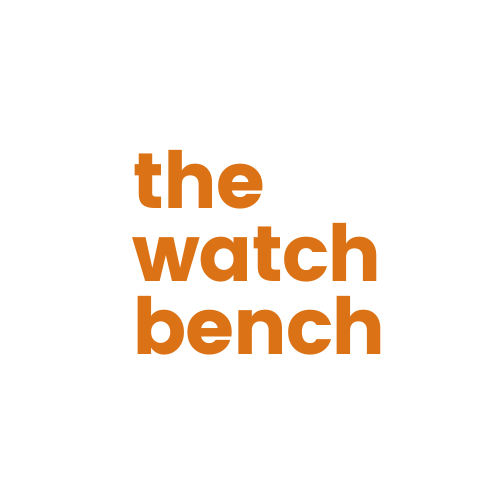 Text logo with orange lettering that says "the watch bench".