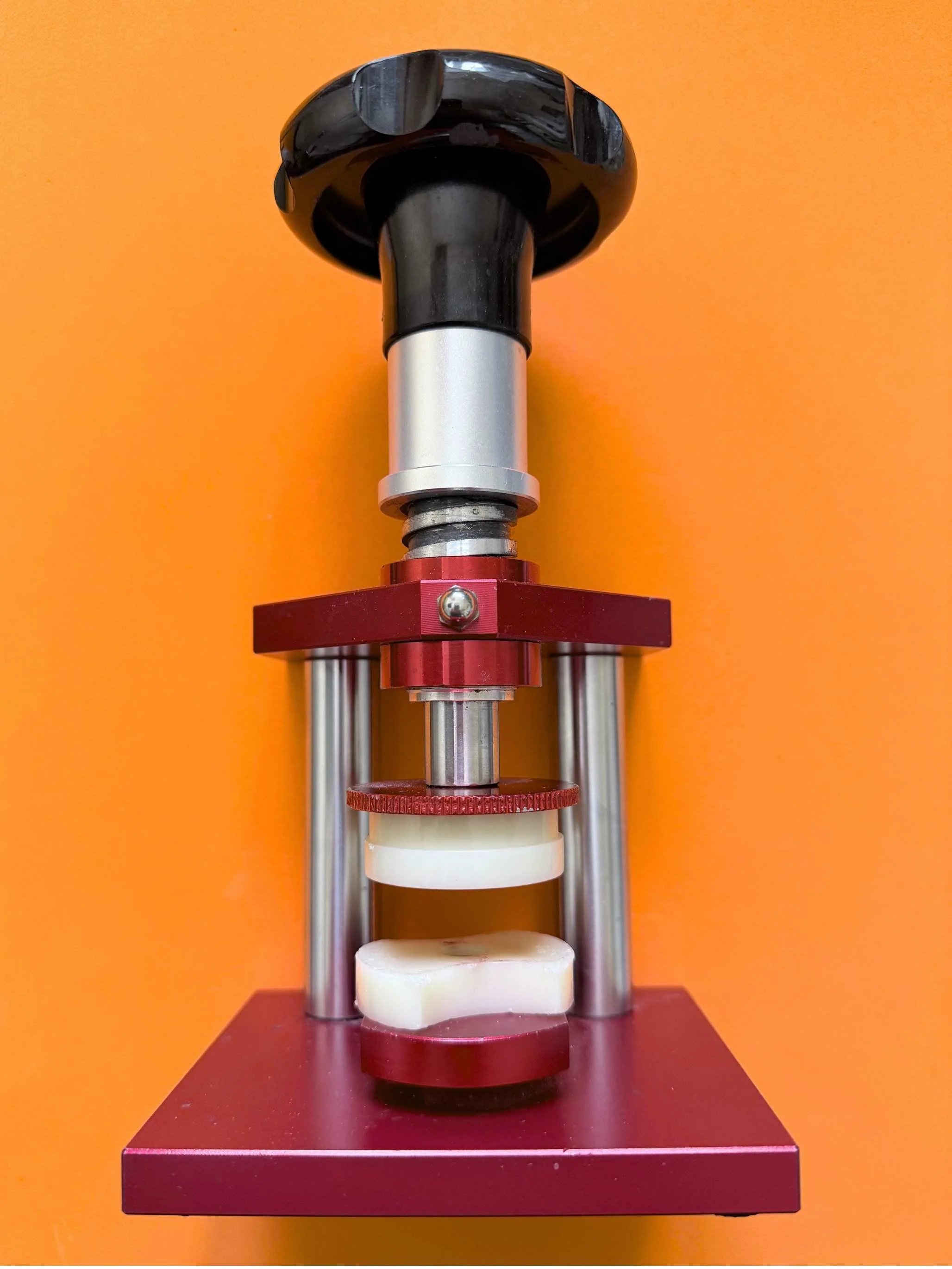 Professional watch case back press used for watch battery replacement and repair, designed to evenly press watch case backs into place without damaging the watch glass or seals.