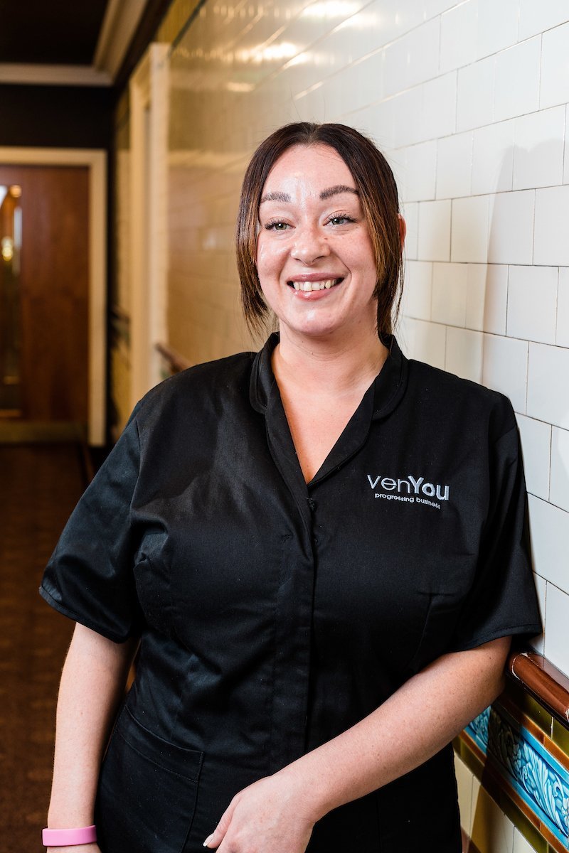 VenYou Client Service Team Member Shanann smiling in the corridor of the Scottish Provident Building.