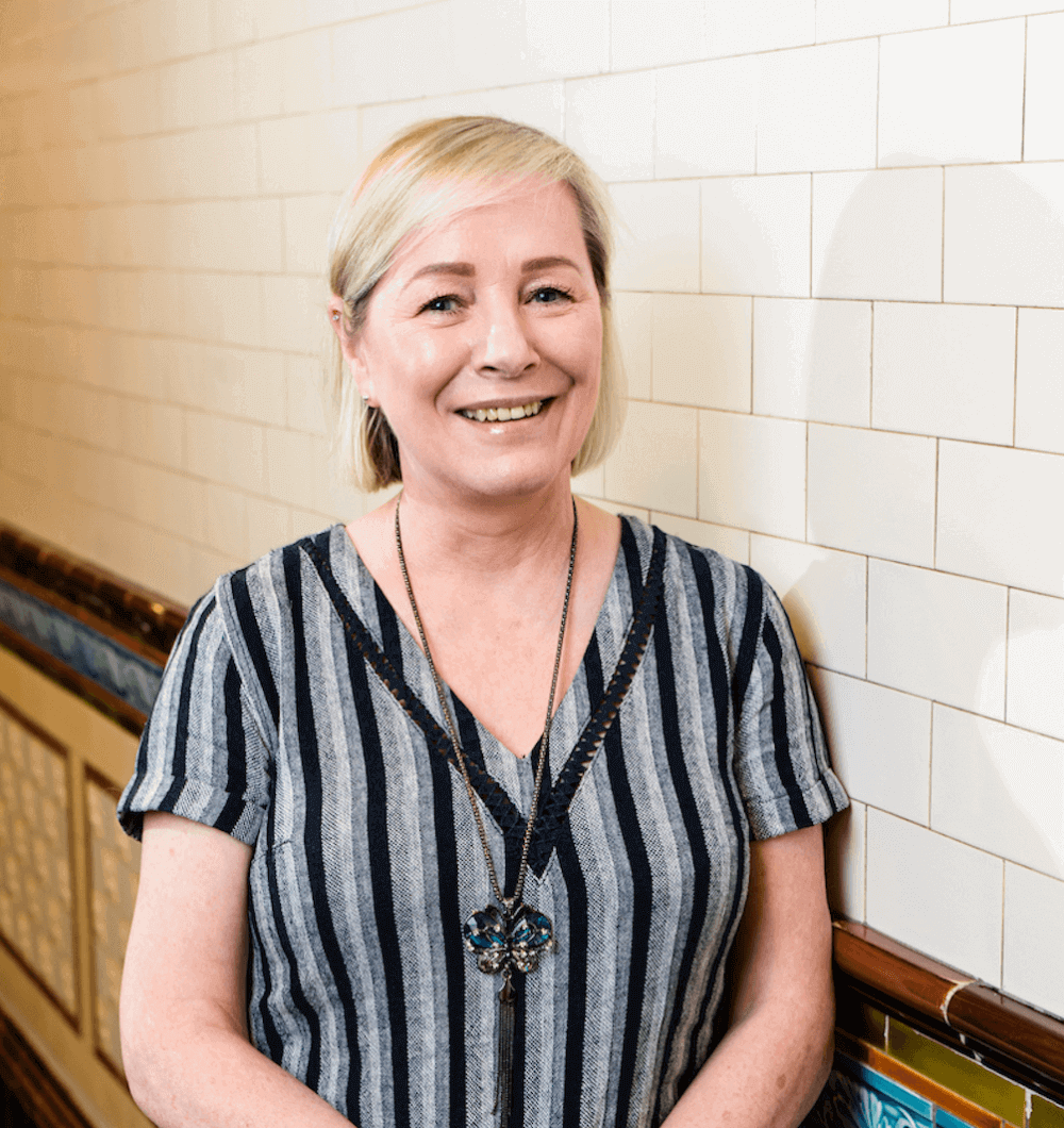 VenYou Client Service Team Member Shanann smiling in the corridor of the Scottish Provident Building.