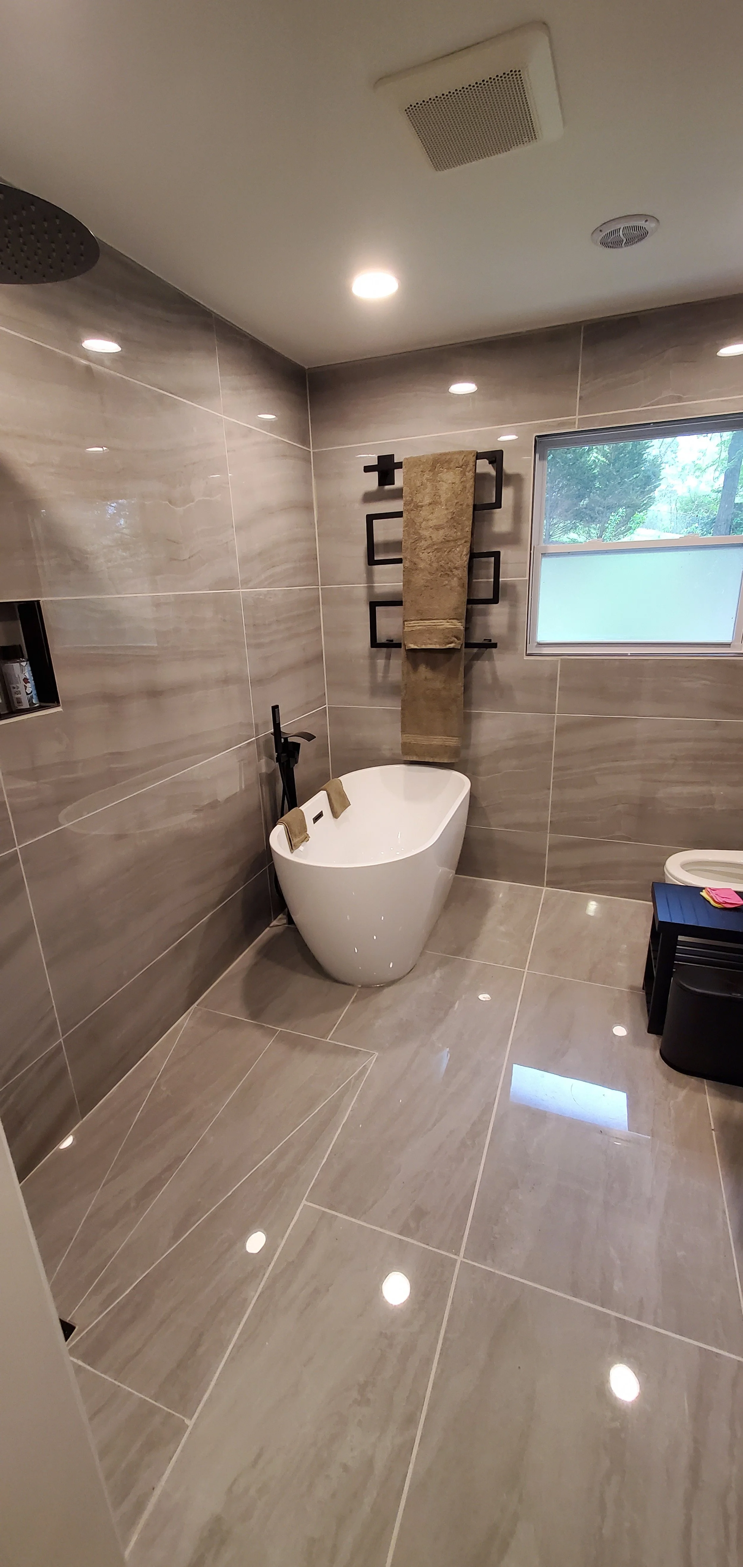 Guest bathroom remodel in Chattanooga, TN, showing tub, heated towel bar, heated floors, walk-in shower, and large format tile
