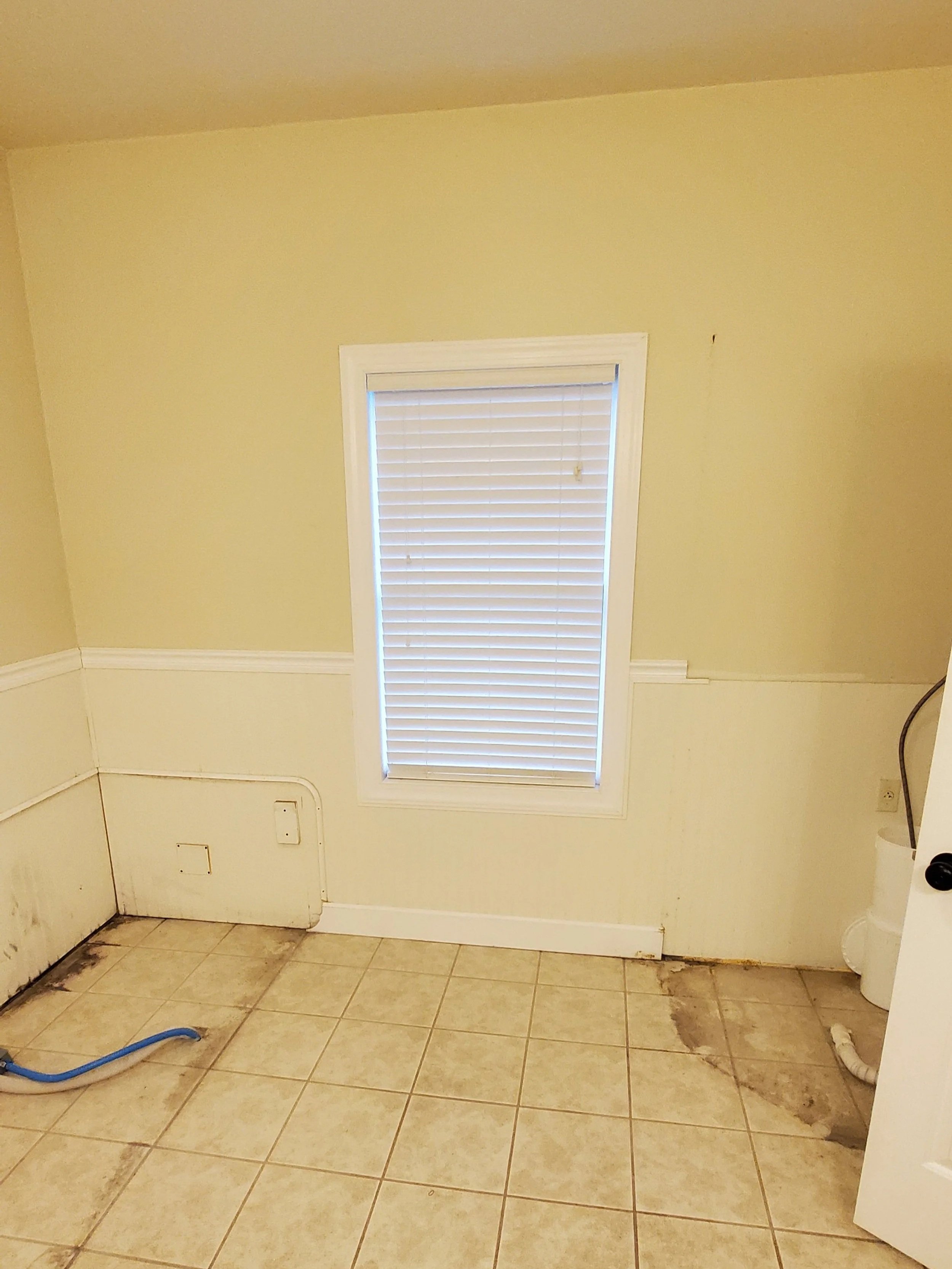Bathroom before remodeling in Athens, TN showing exterior wall where tub and shower used to be