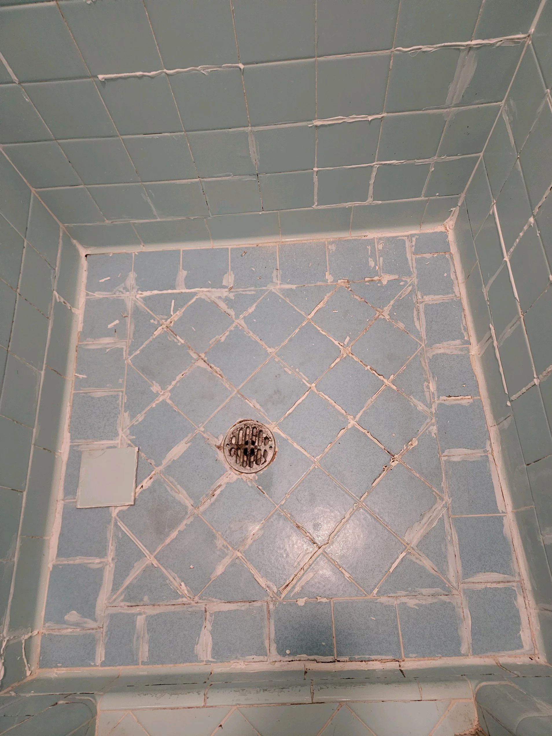 Master bath renovation in Chattanooga, TN, showing old shower tile floor