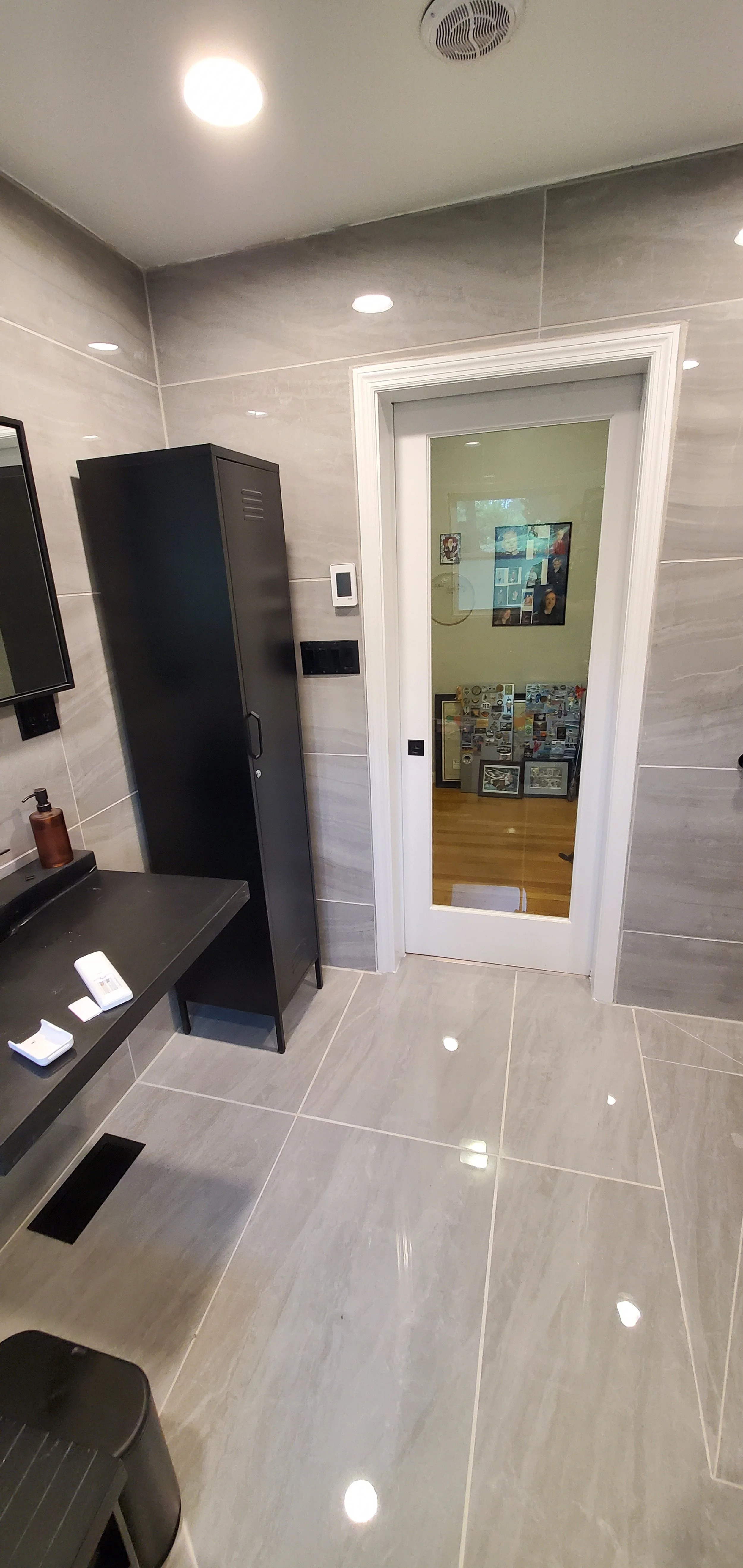 Guest bathroom remodel in Chattanooga, TN, showing custom concrete sink and pocket door