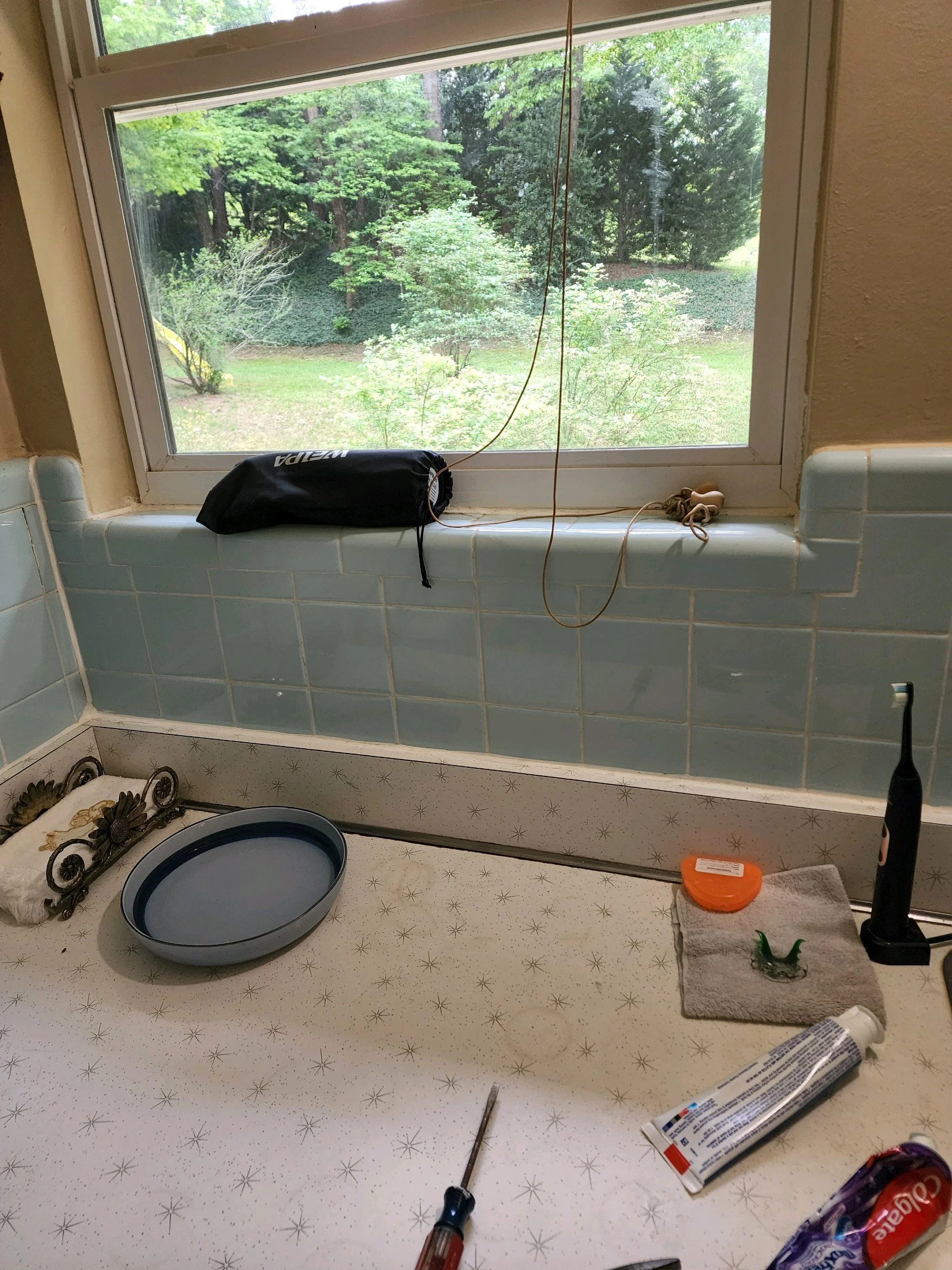 Master bath renovation in Chattanooga, TN showing old wall tile, vanity, and window