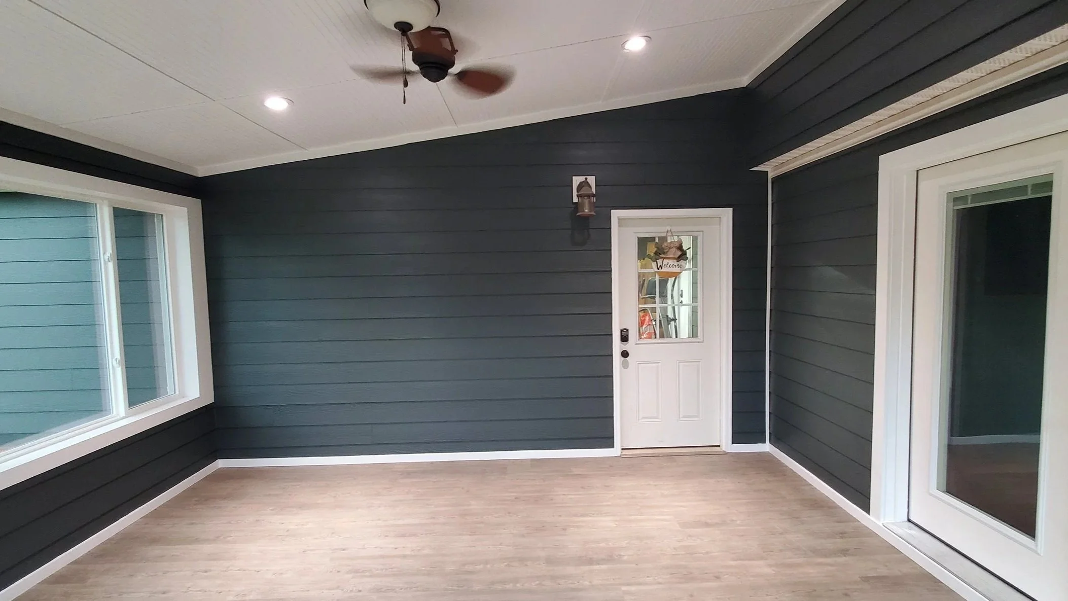 Porch conversion in Dayton, TN, showing finished LVP floors and finished ceiling from sliding doors