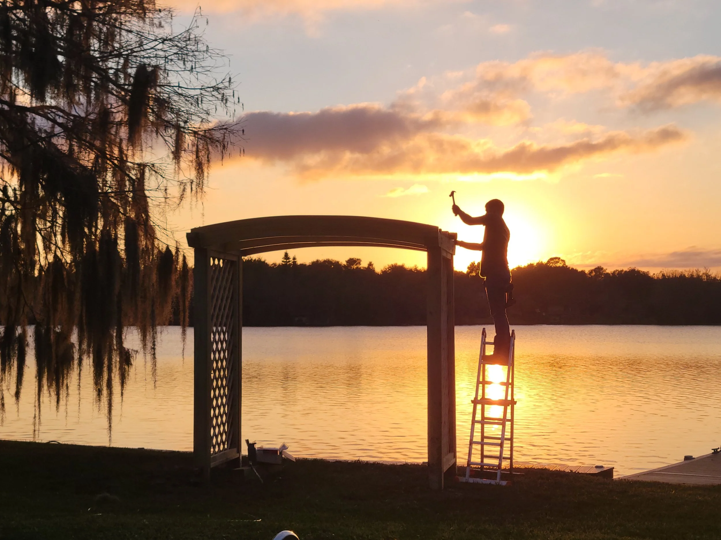 Custom swing arbor at lake house showing custom arches being attached