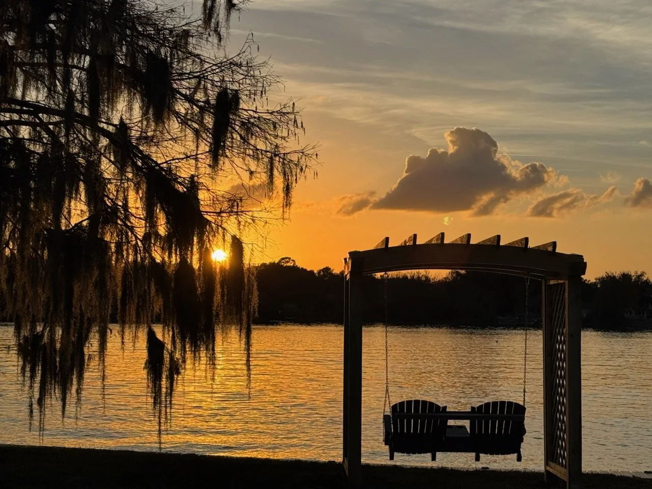 Custome lakefront swing arbor at sunset