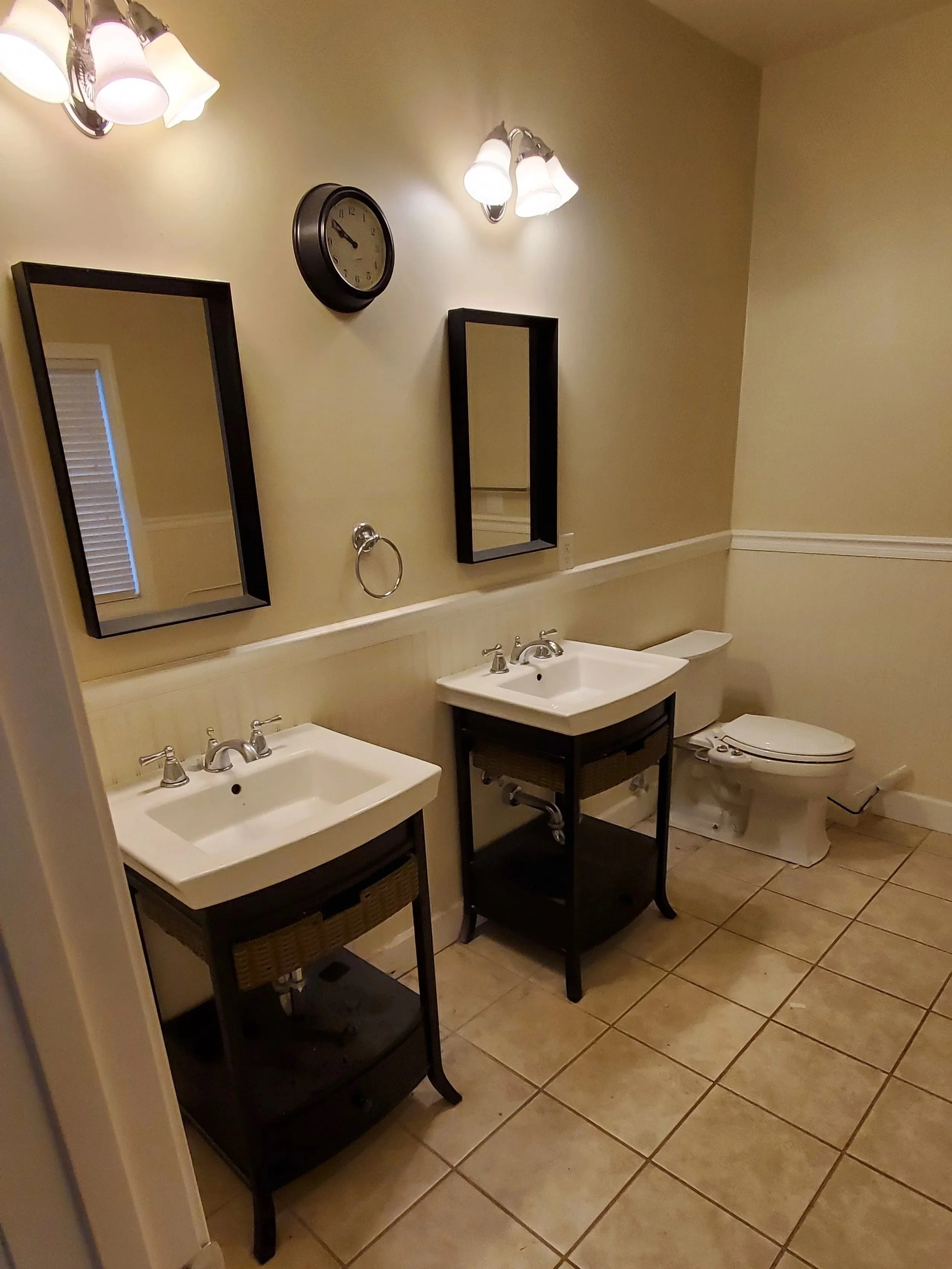 Bathroom remodel in Athens, TN showing vanities and toilet from doorway