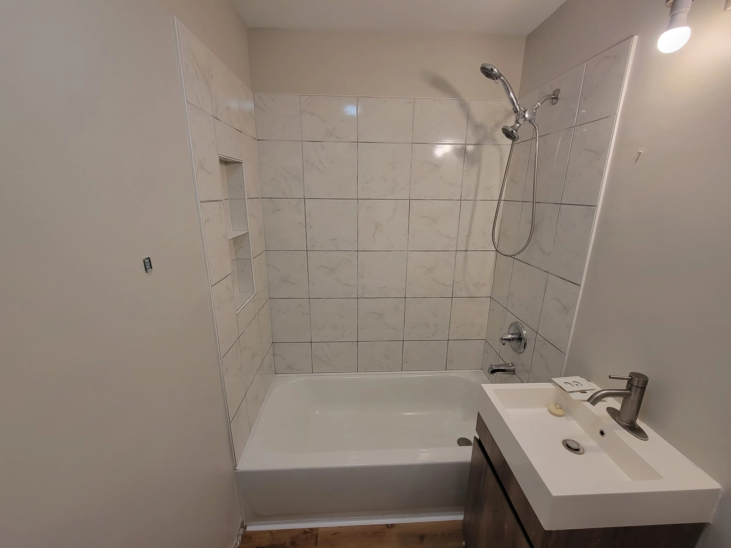 Replaced fiberglass tub surround with tile and a built in niche in Spring City, TN