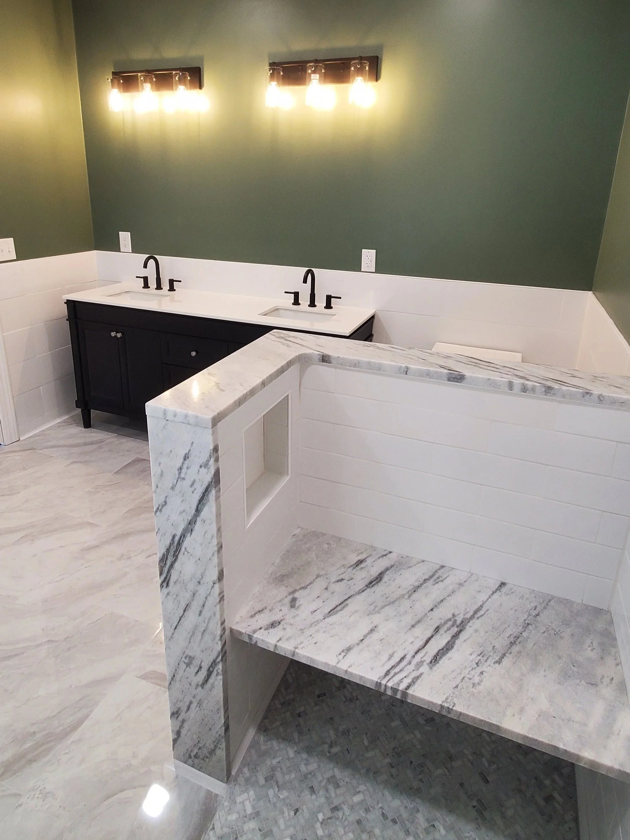 Accessbile bathroom in Athens, TN showing accessible tile shower with bench, heated tile floor, new vanity and light fixtures