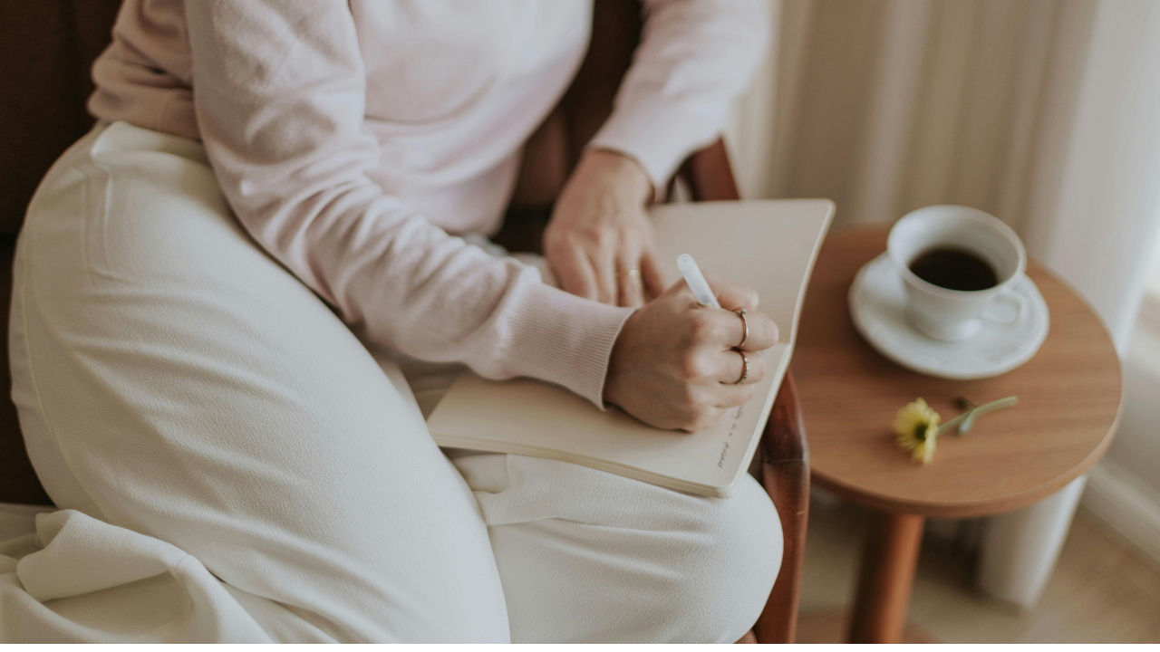 Woman journaling with coffee, a quiet moment of reflection