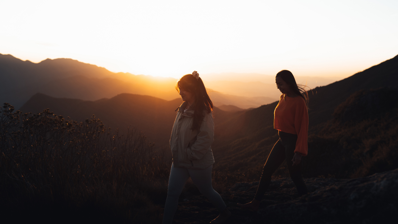 Two women hiking together at sunset in the Berkshires