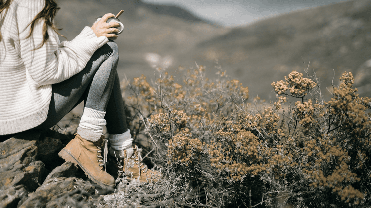Woman sitting quietly alone in the Berkshires hills, a moment of individual reflection