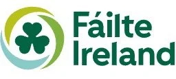 Fáilte Ireland logo with a green shamrock inside a circular design.