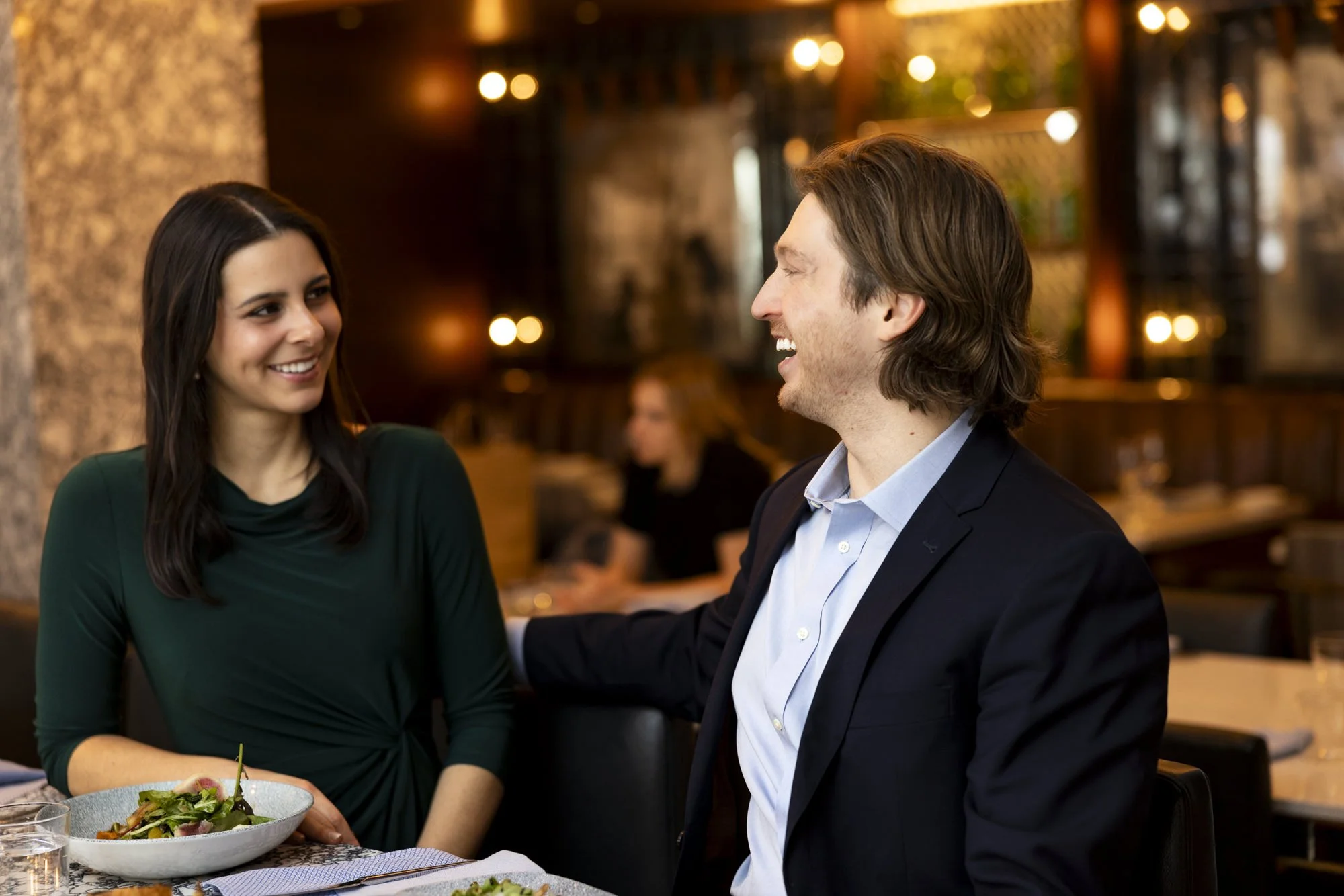 Guests laugh with each other while dining at Via Sophia.