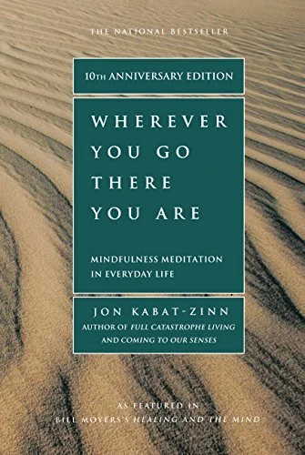 Book cover of 'Wherever You Go, There You Are' 10th Anniversary Edition by Jon Kabat-Zinn, featuring a sandy landscape background.