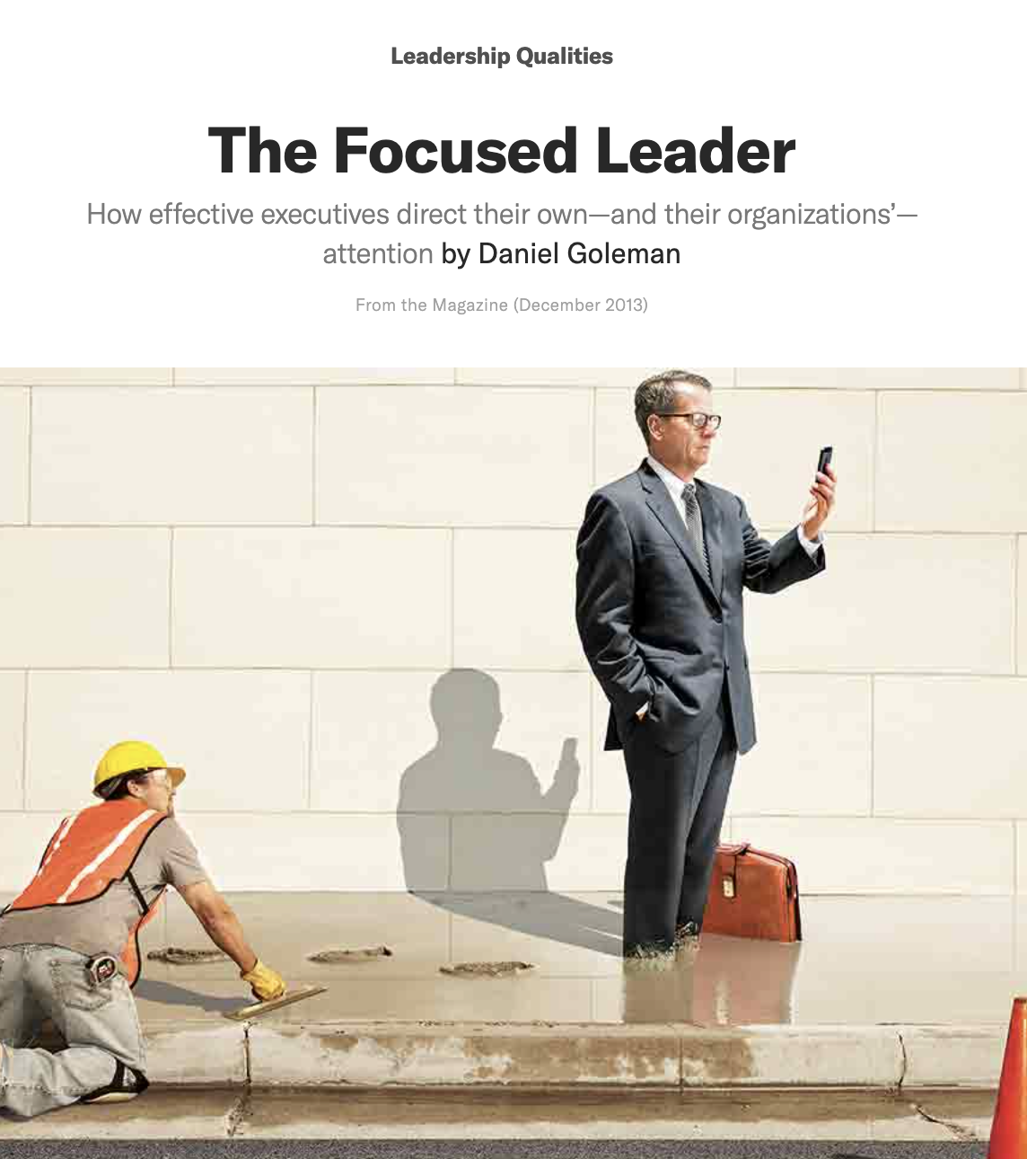 Businessman in suit standing in wet cement while using a smartphone, with construction worker in hard hat kneeling nearby, against a tiled wall.