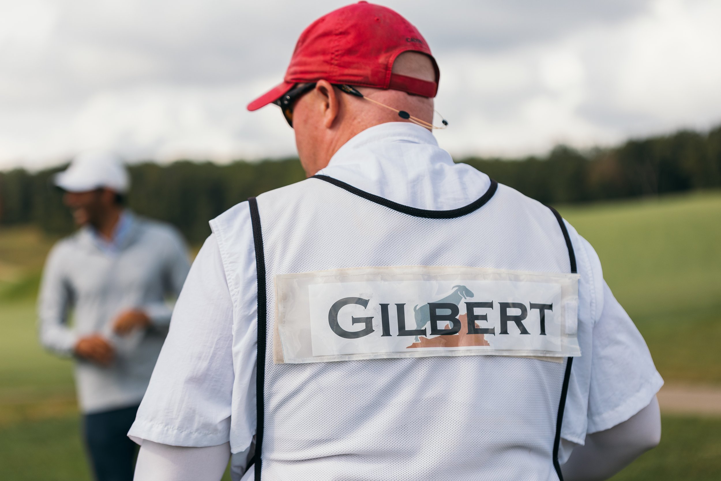  A caddie caddying for country-music singer, Brantley Gilbert with “Gilbert” written on his shirt.