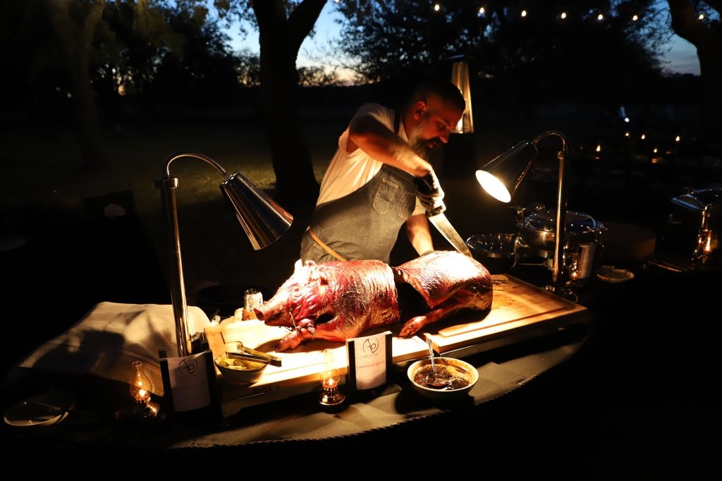 A chef preparing a roasted pig