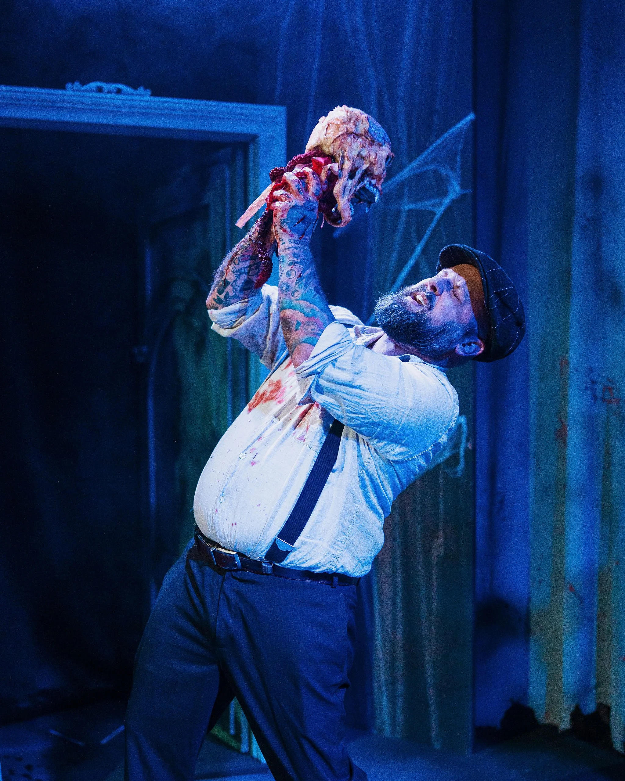 a man holding a bloody skull from his face