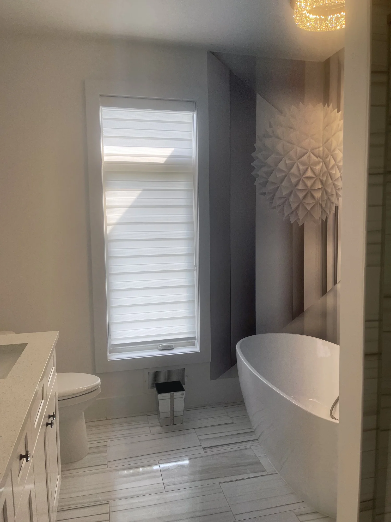 Freestanding tub beside a bright window