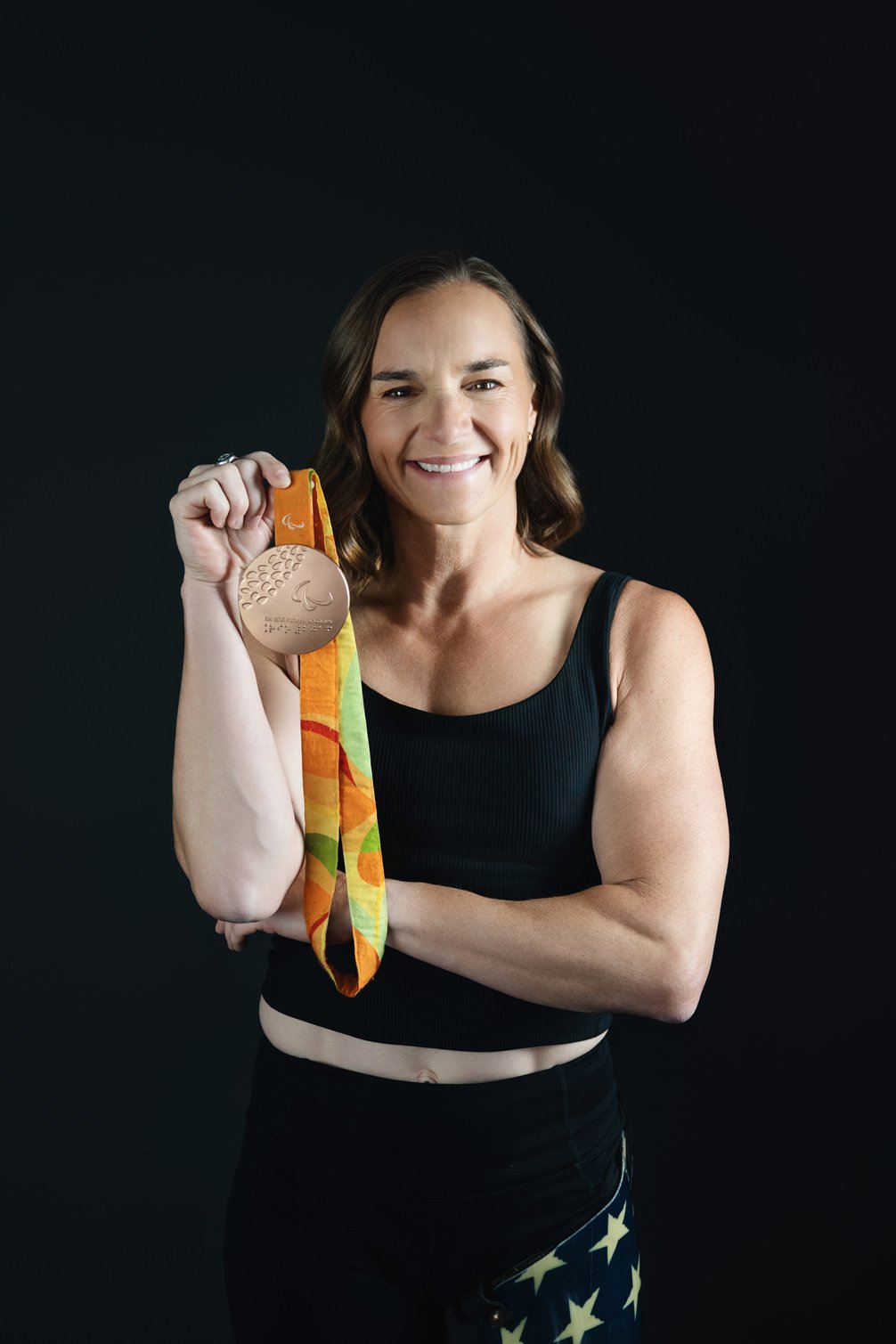 Photo of Melissa Stockwell with her Olympic medal, smiling