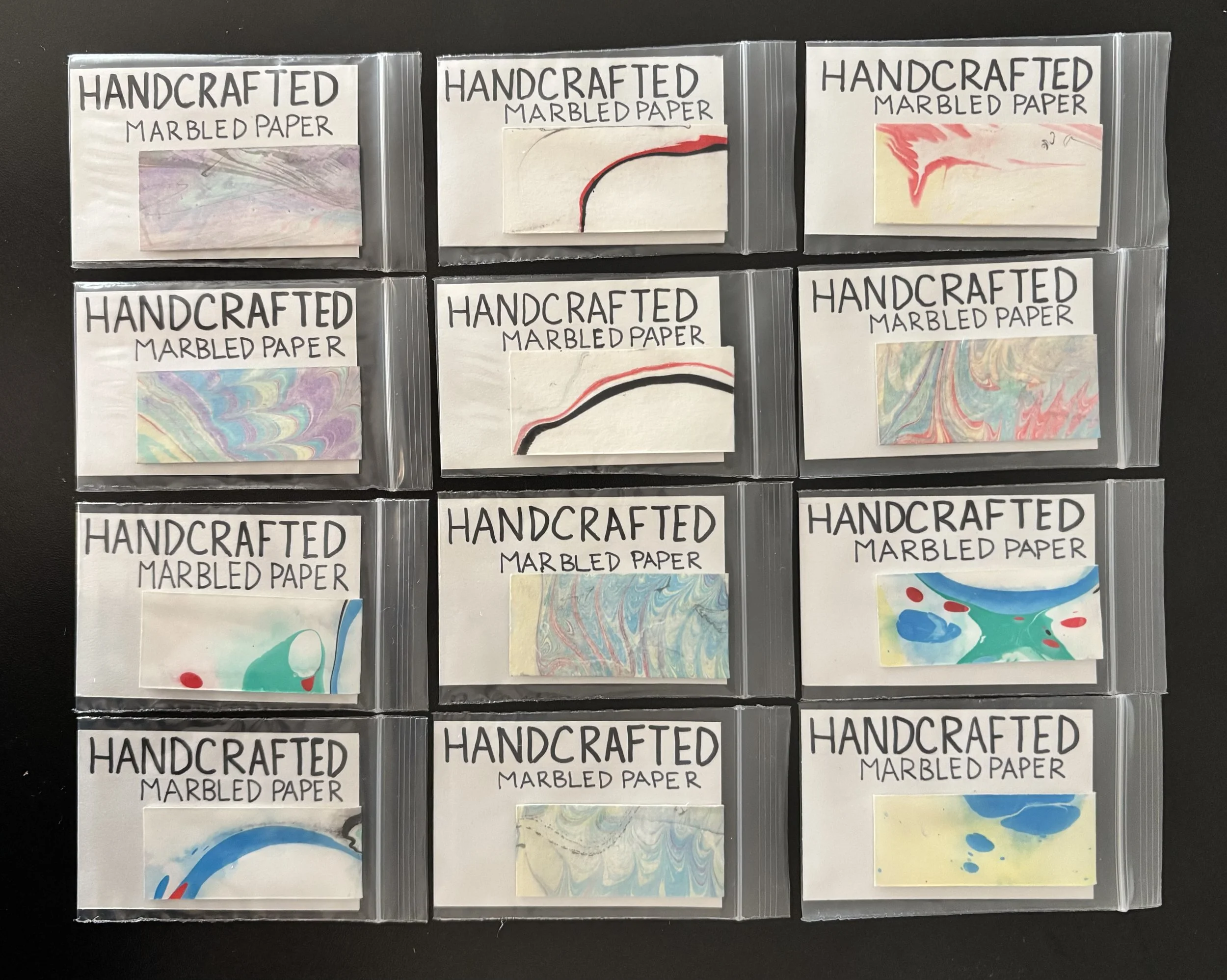 Collection of paper marbled magnetic bookmarks. Exhibiting at Starke Naked Vintage in Bellport, NY in May 2026