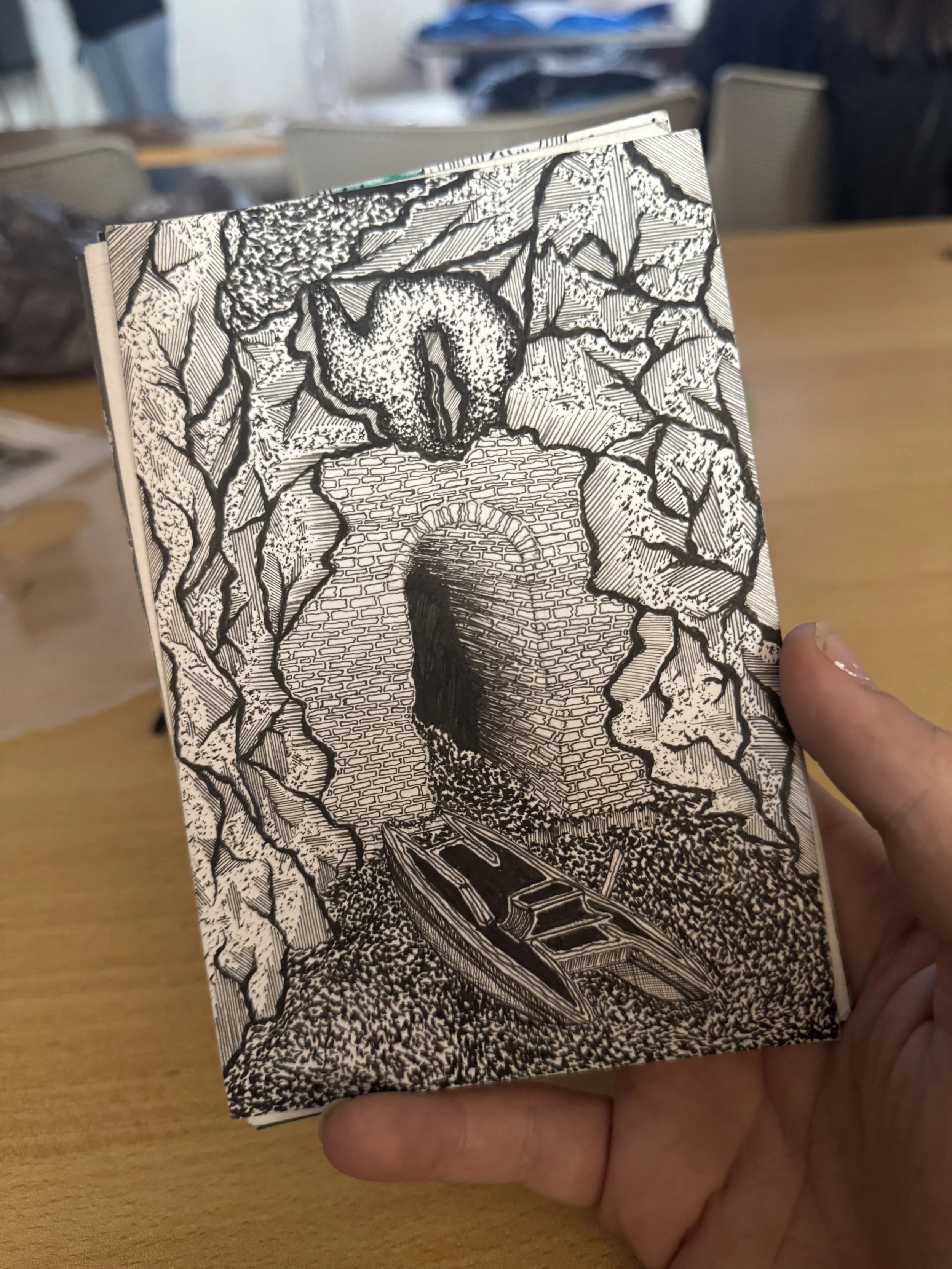 A postcard of the caves of Capri with the entrance to the beach and a boat.