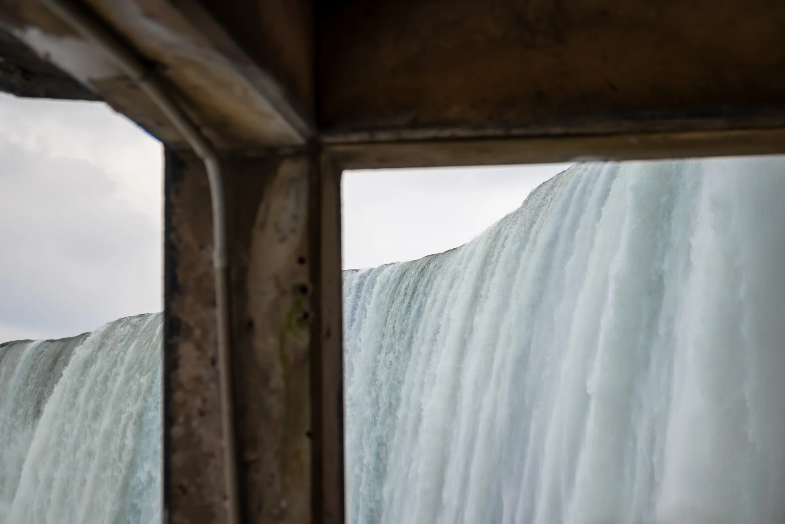 Photograph taken from beneath Niagara Falls, looking upward through the misty tunnels.