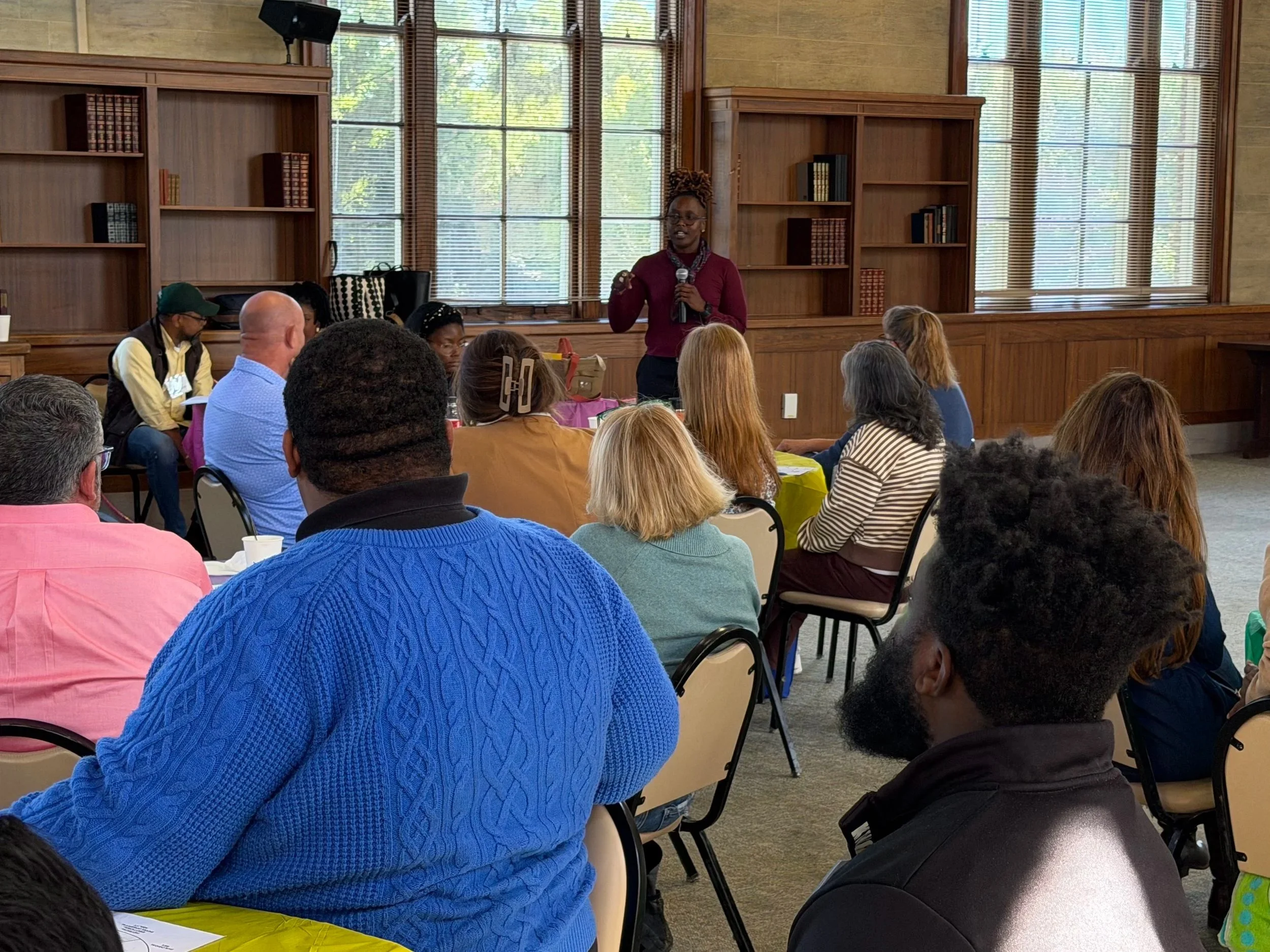 A BLACK WOMAN SPEAKS IN FRONT OF LARGE MULTIRACIAL GROUP - PSA