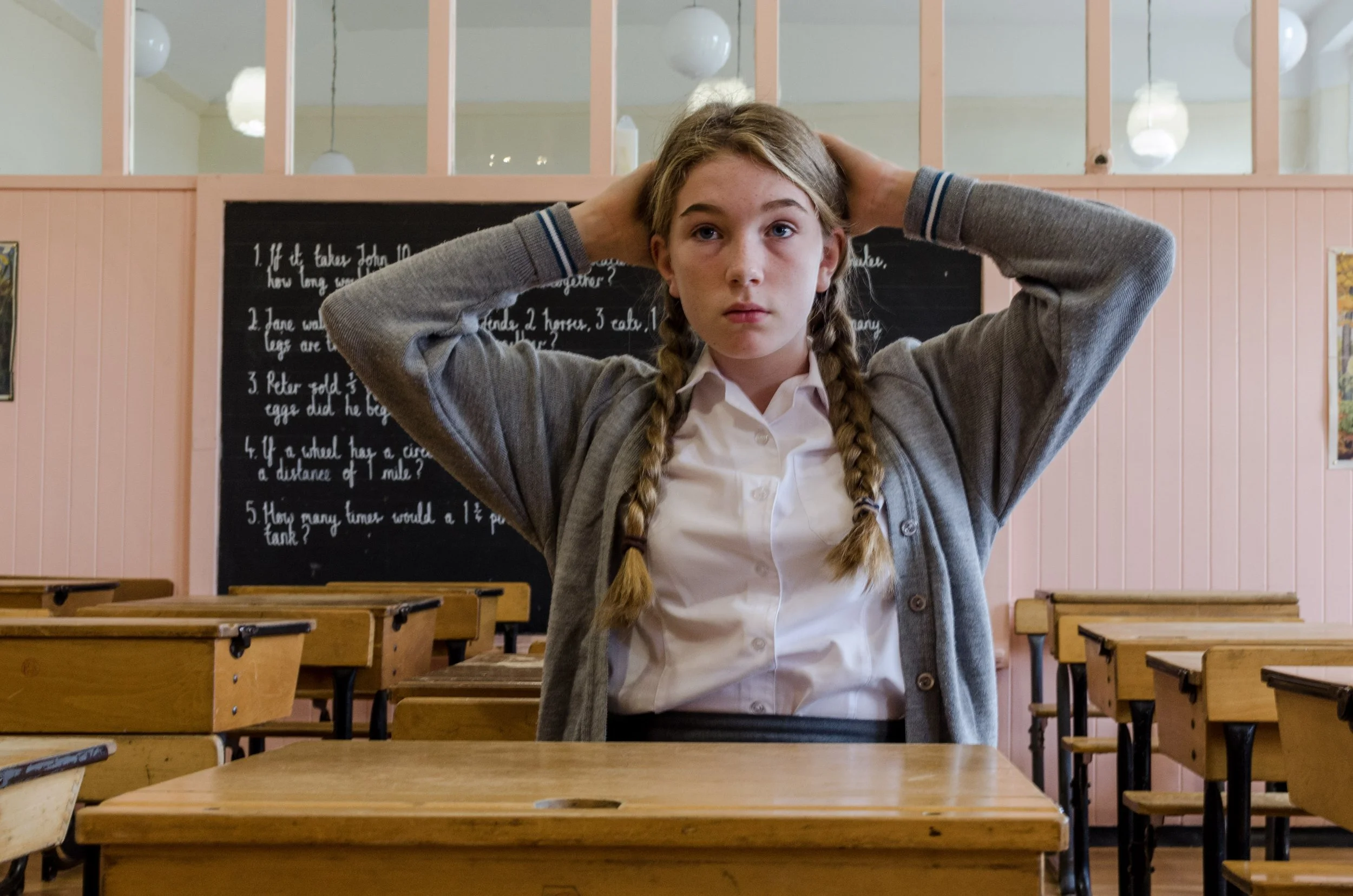 Teen at school desk working on breathing exercise to energise