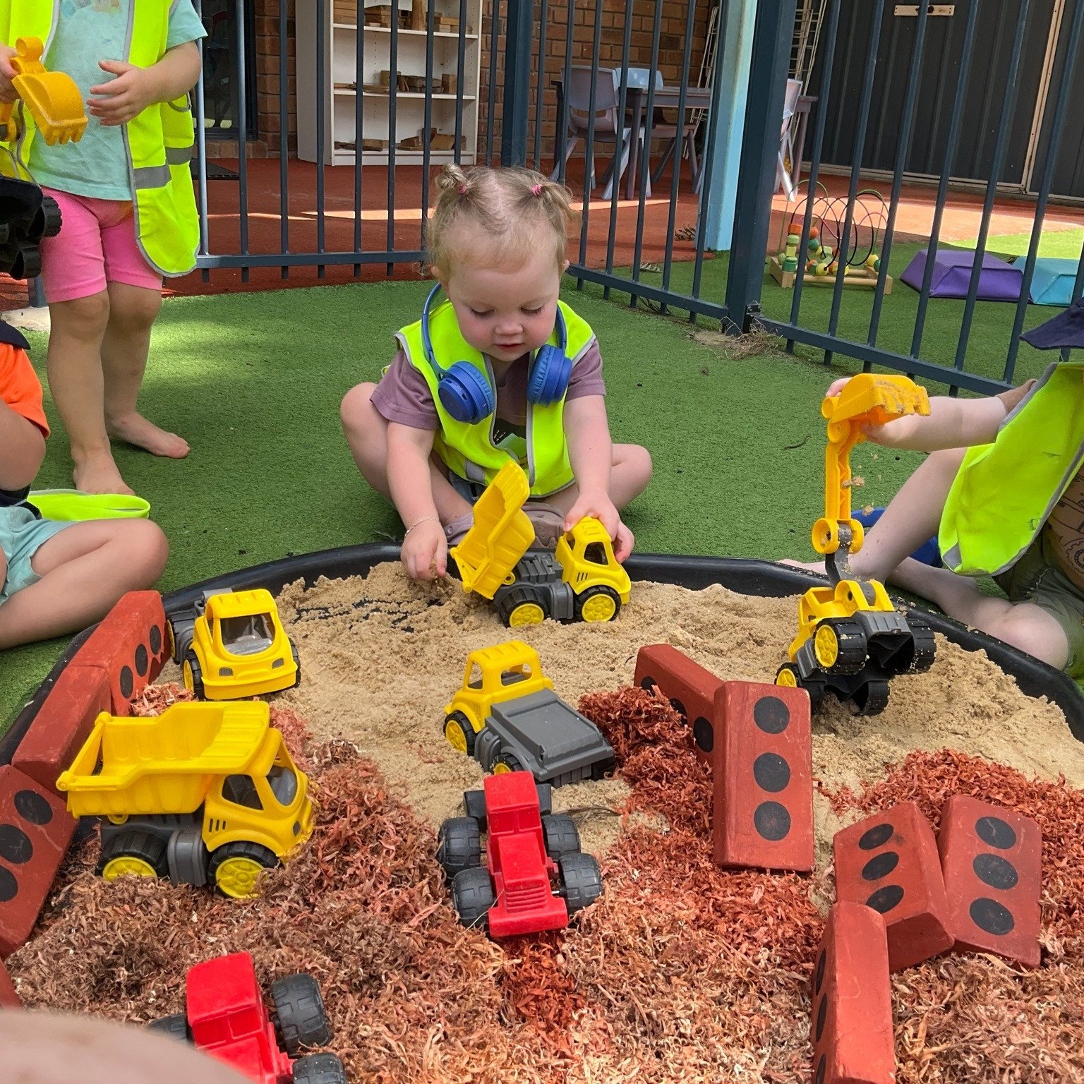 🚧 High vis gear is on so let's build! 🧱👷
Our little crew got busy in the sandpit, transforming it into a mini construction site with excavators, play bricks, brick-coloured shavings and their very own construction gear!
Dressed in high-vis vests