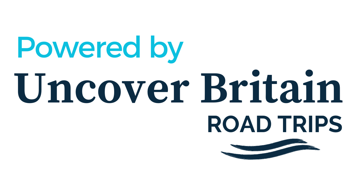 Logo with text 'Powered by Uncover Britain Road Trips' in blue and black lettering with a wave graphic.