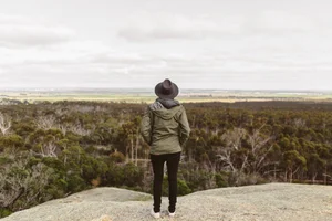 A woman looking out across a scenic viewpoint on a UK road trip