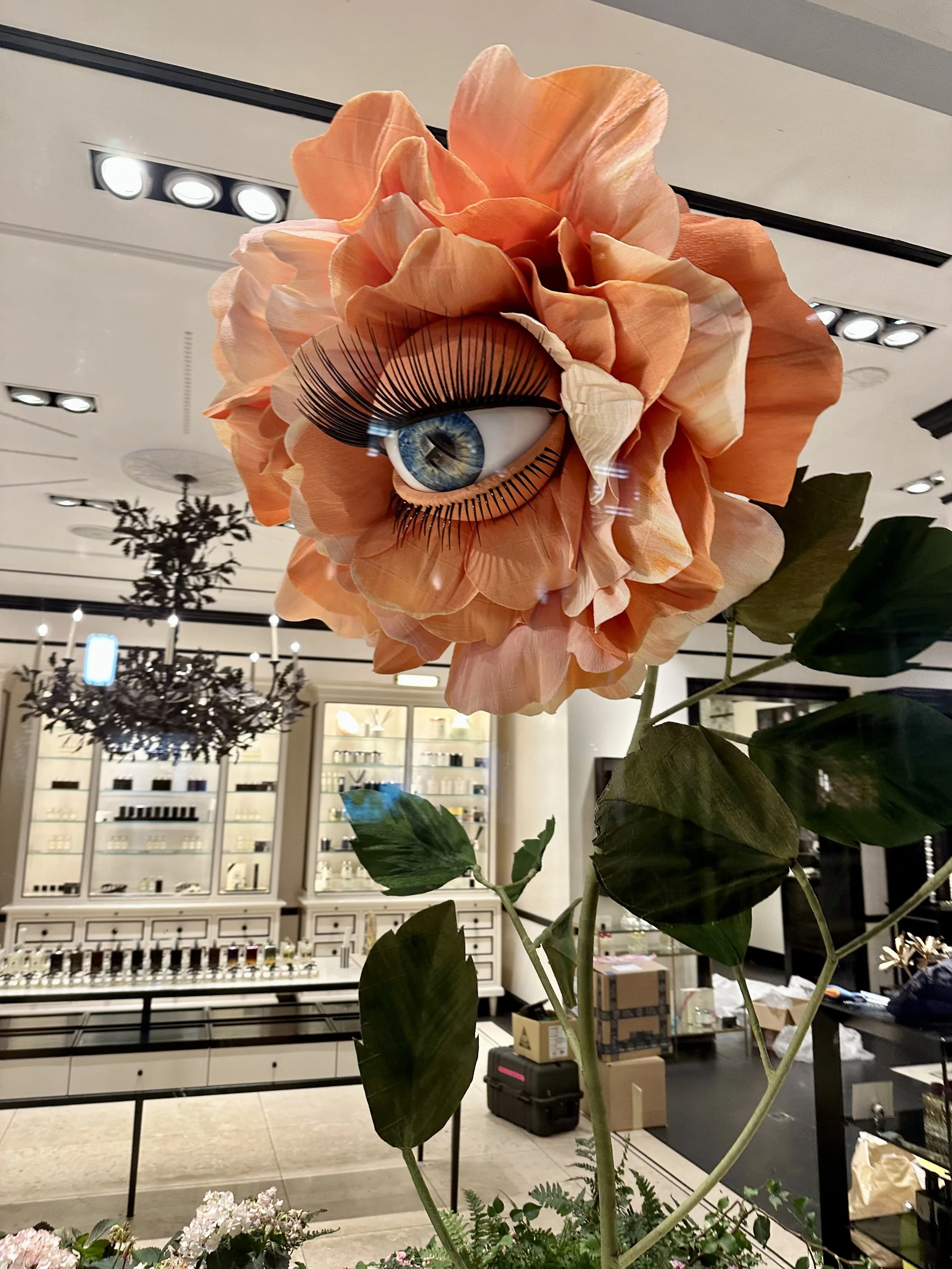 Giant peach rose flower display with big blinking eye