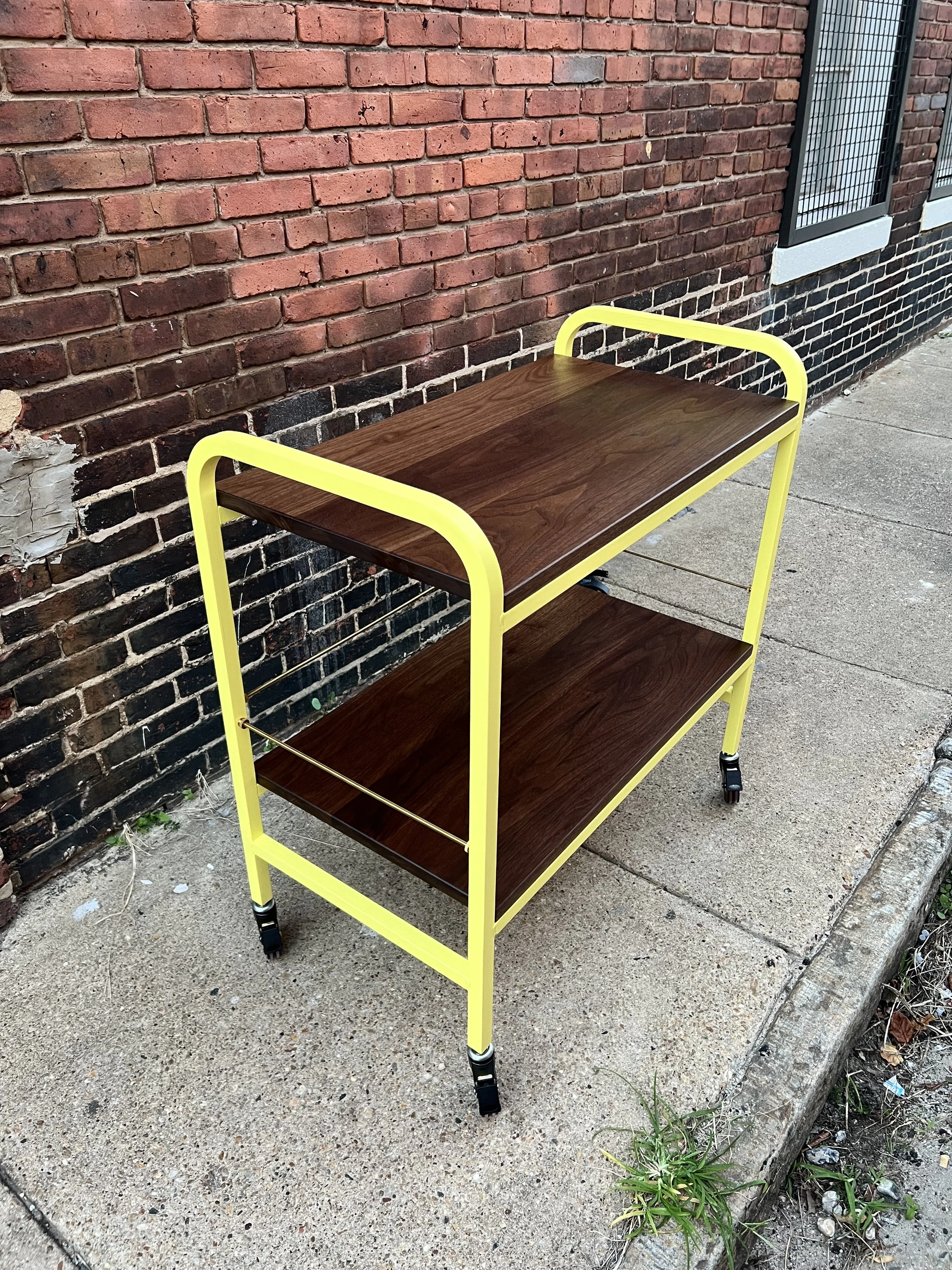 Mobile changing table in walnut with brass accents